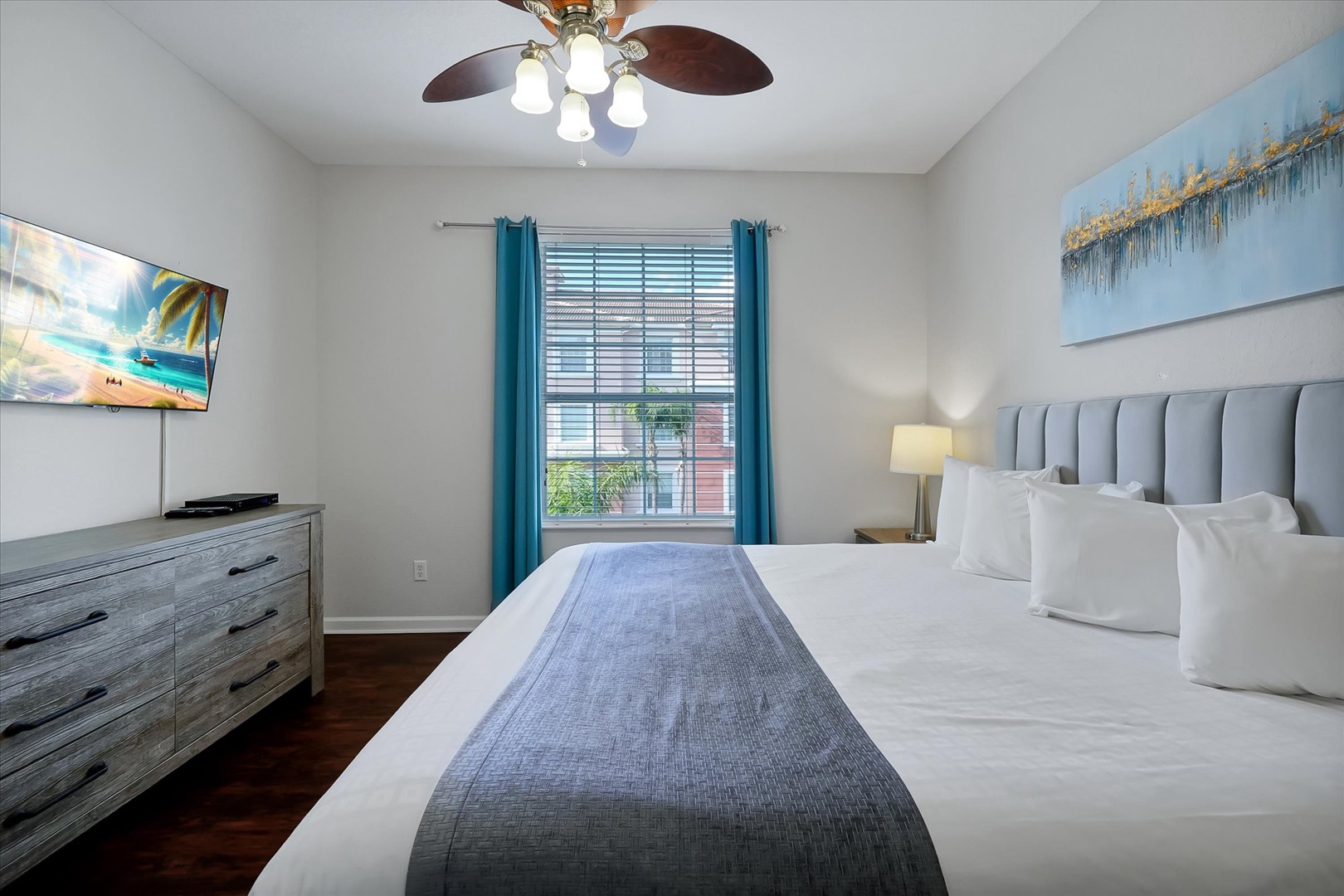 Unwind in your peaceful retreat with crisp linens, beach artwork, and turquoise accents creating the perfect coastal sanctuary for rest.