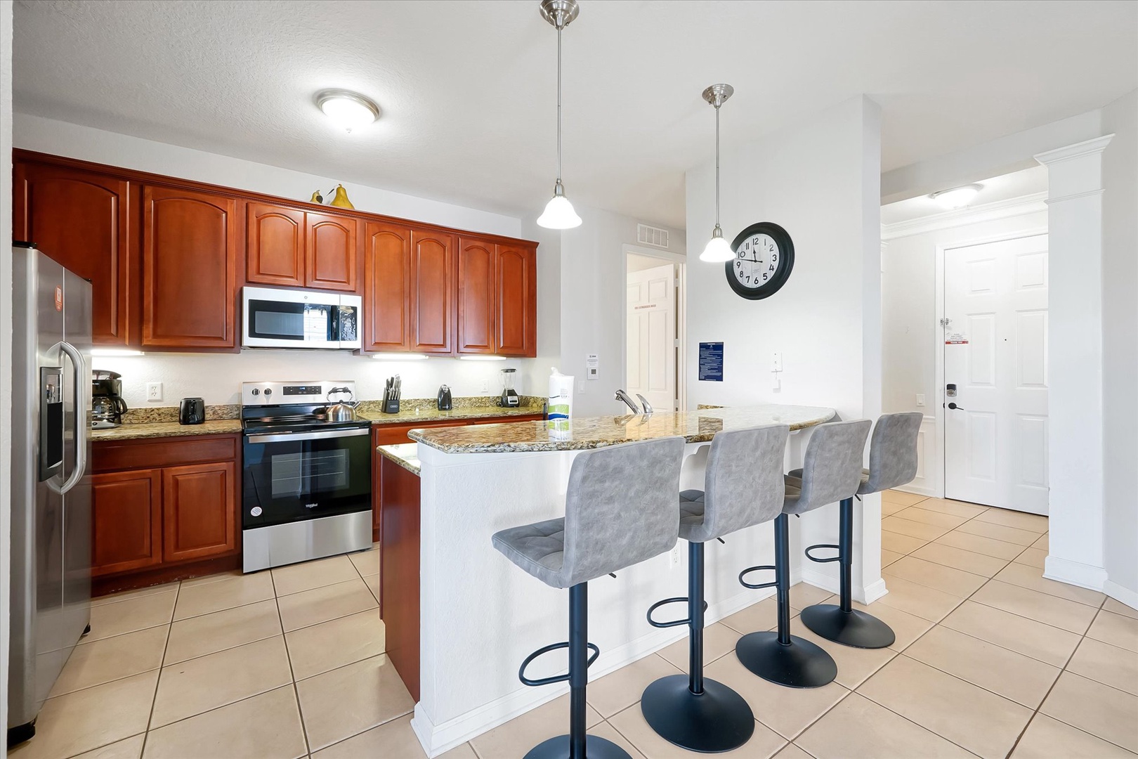 Your fully-equipped kitchen welcomes you with granite countertops, stainless steel appliances, and a breakfast bar perfect for morning coffee or casual meals.