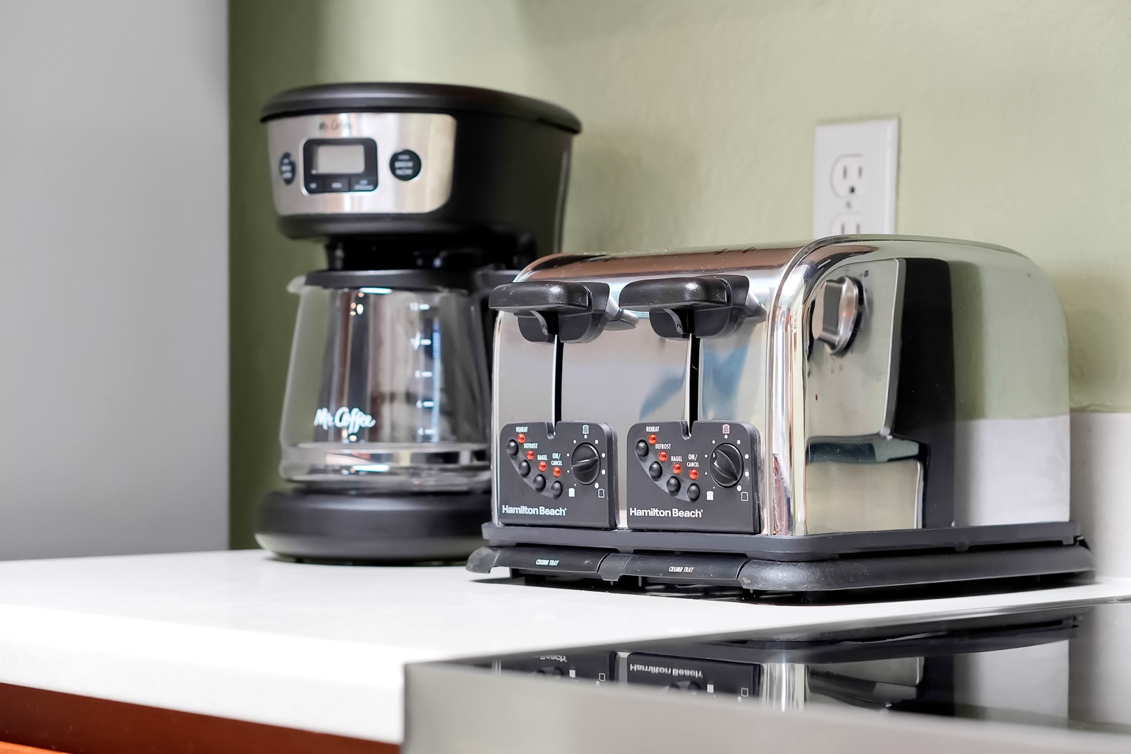 Start your mornings right with premium coffee and toaster facilities at your fingertips in this well-equipped kitchen space.