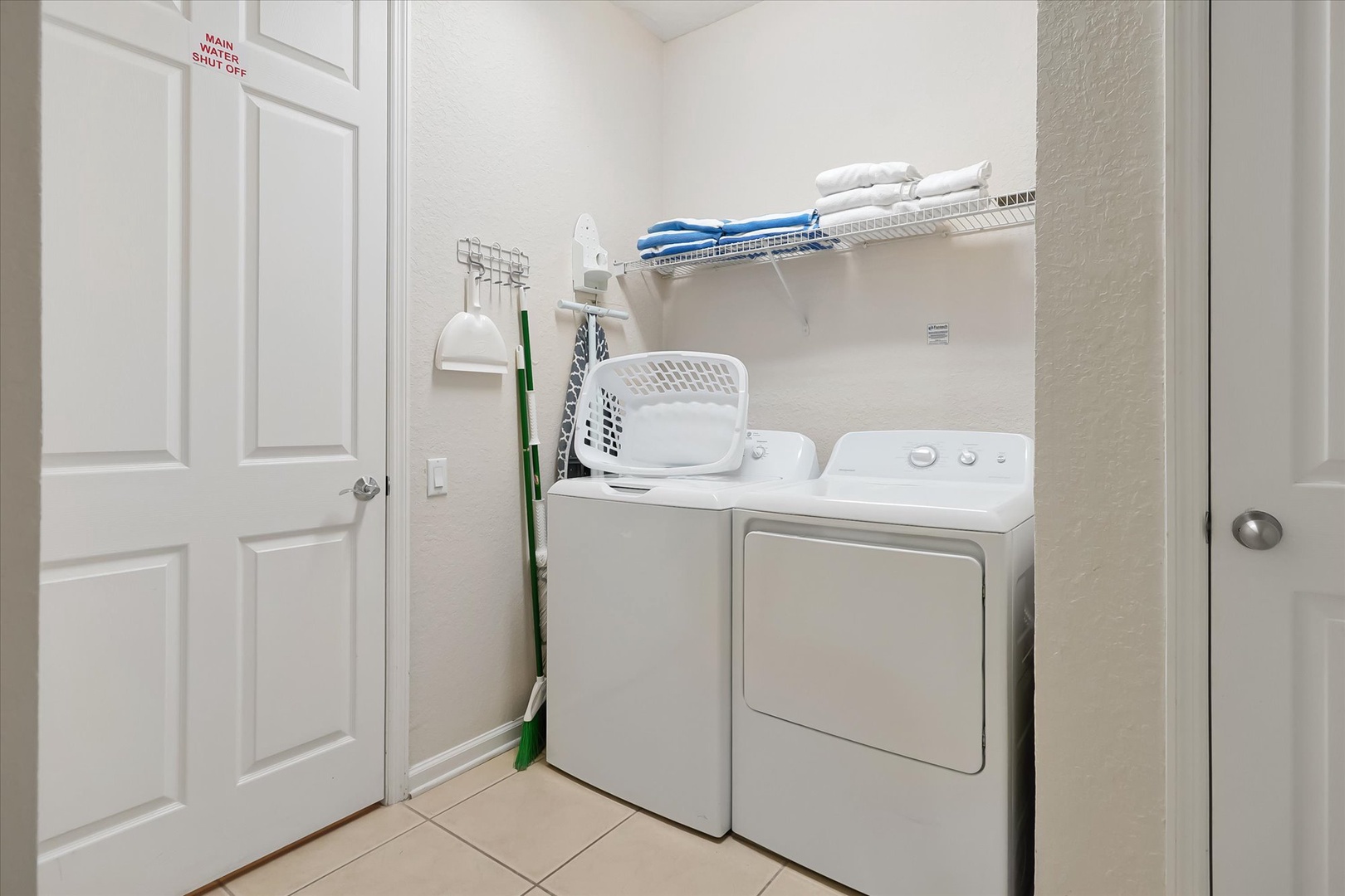 Your own private laundry room keeps clothes fresh with full-size washer and dryer, plus organized shelving for supplies.