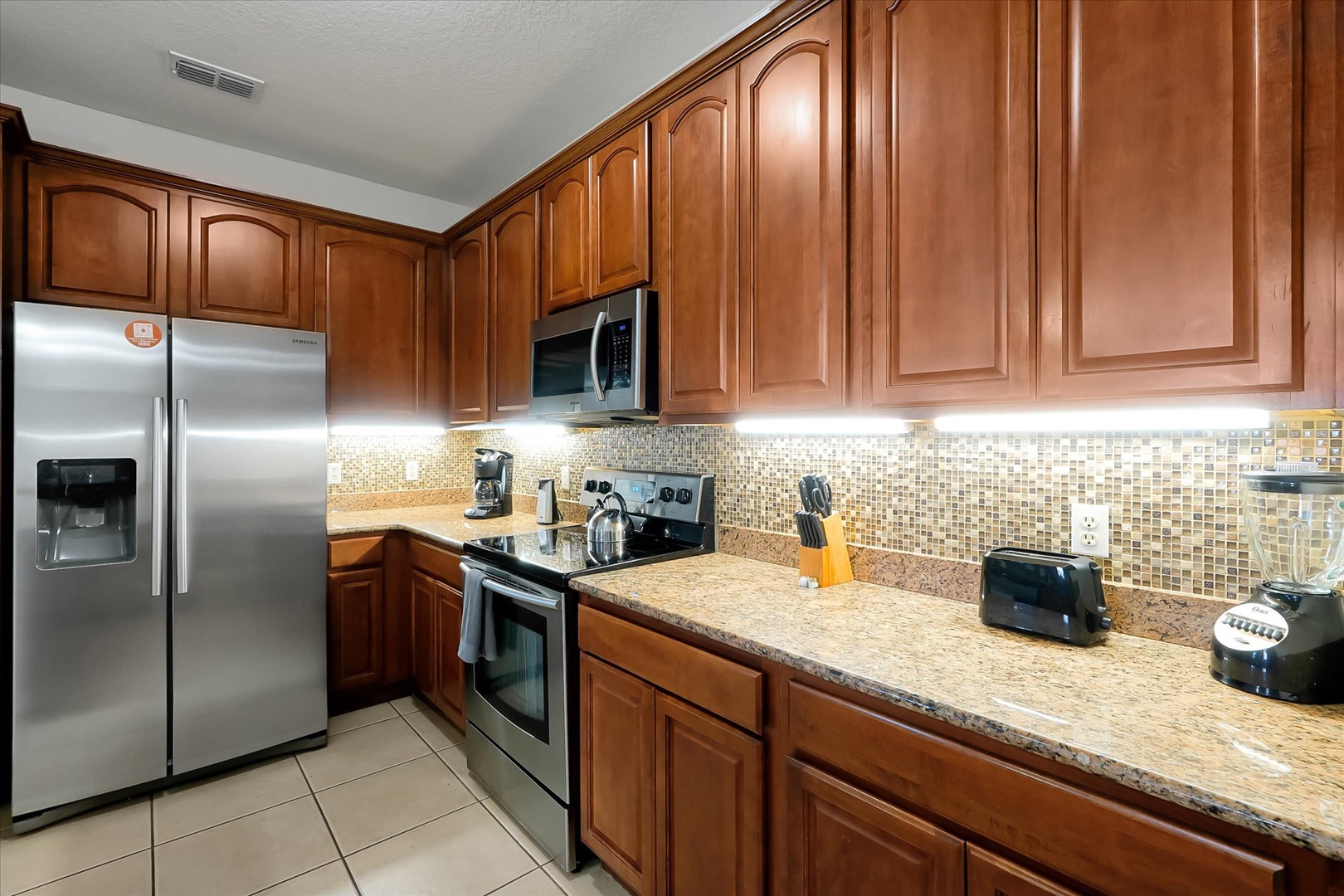Your fully equipped kitchen features granite counters, stainless steel appliances, and warm cherry cabinets for memorable meal prep.