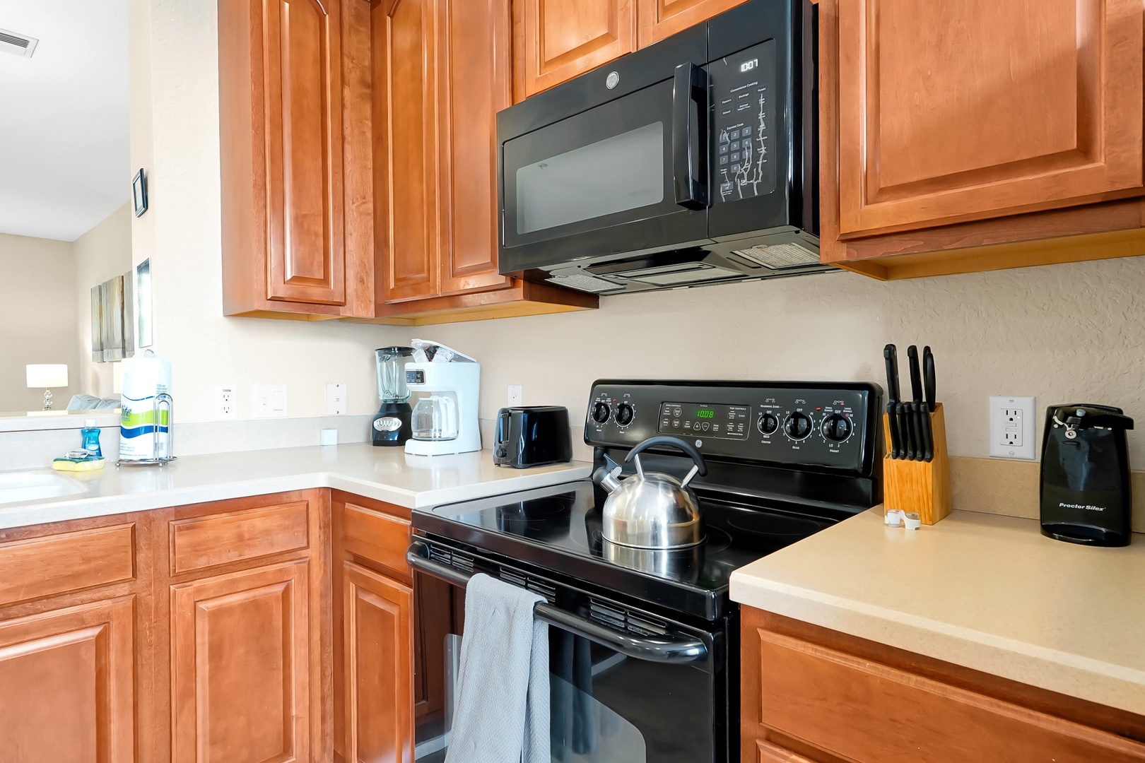 Your fully equipped kitchen awaits with modern appliances and warm wood cabinets, perfect for preparing meals during your stay.