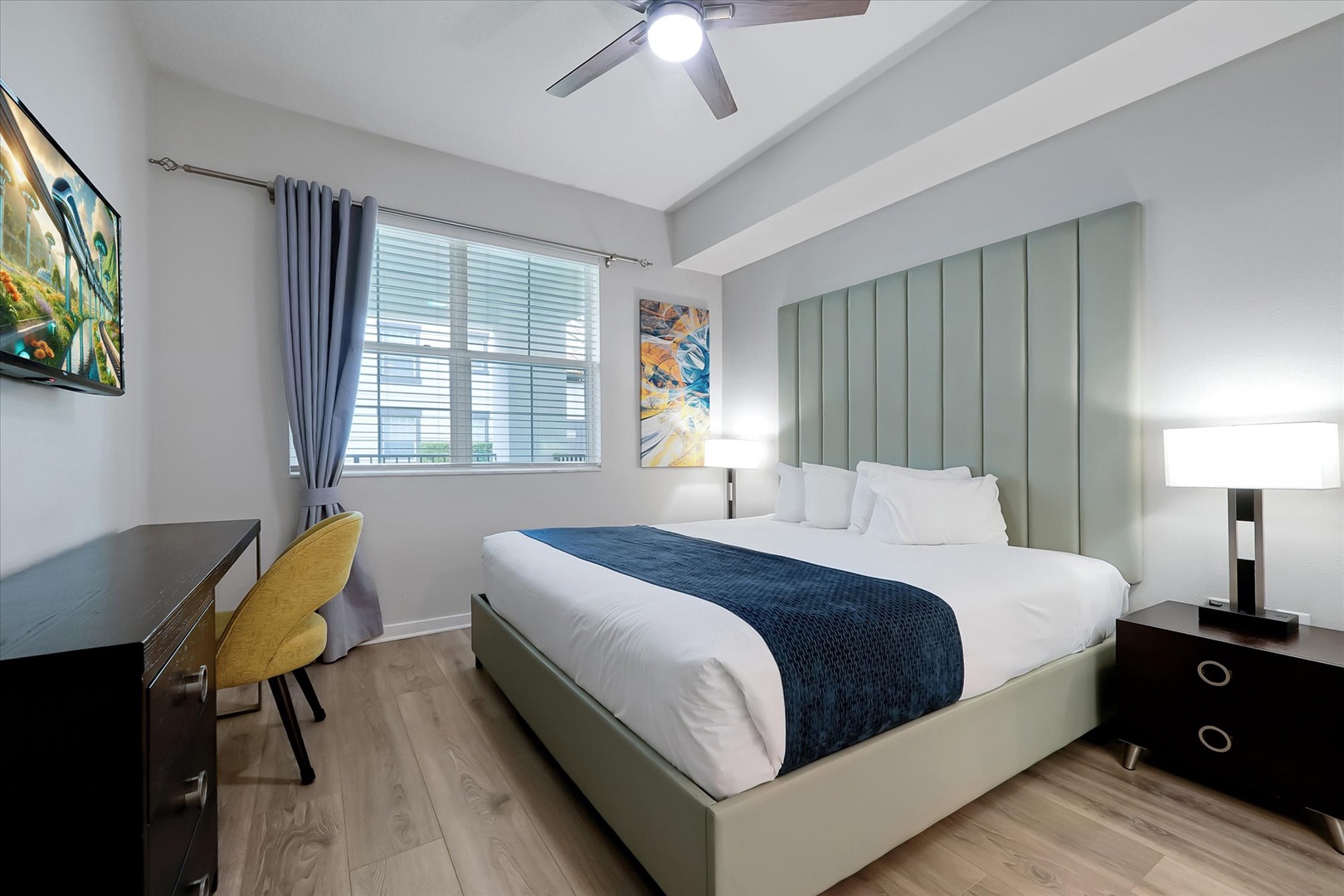 Sink into crisp white linens and modern comfort in your stylish bedroom, complete with workspace and city views.