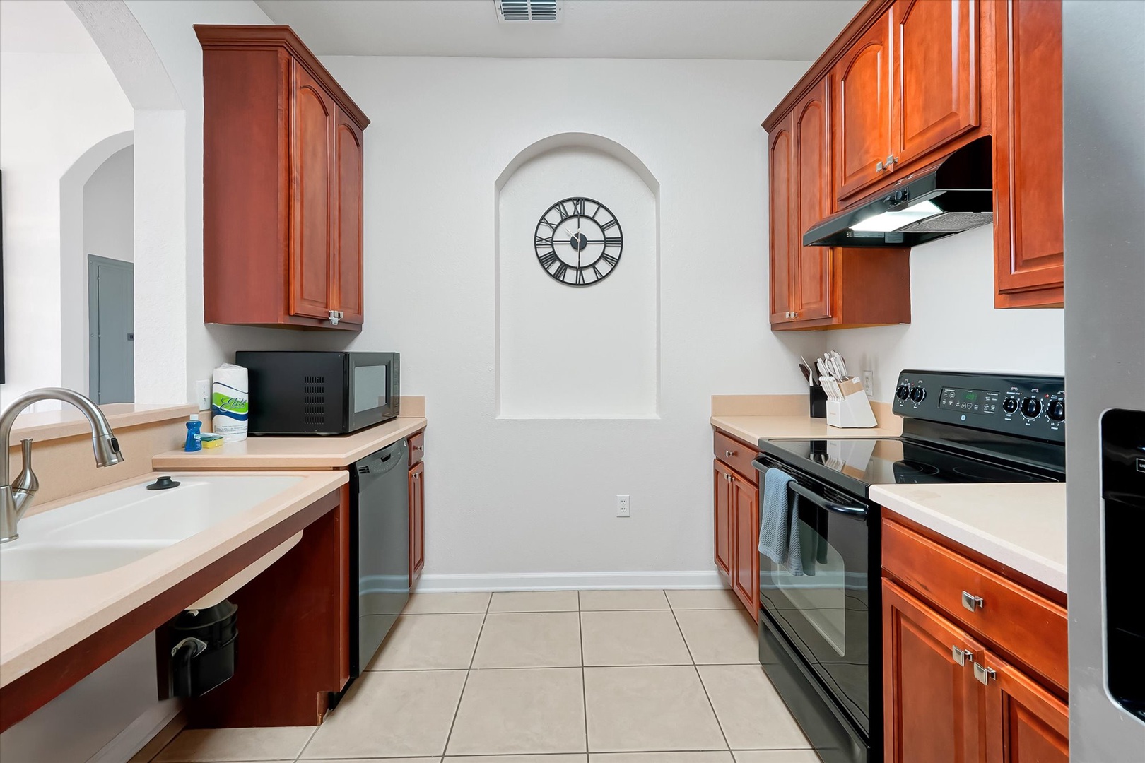Your fully equipped kitchen awaits with warm cherry cabinets, modern appliances, and everything needed to create memorable meals during your stay.