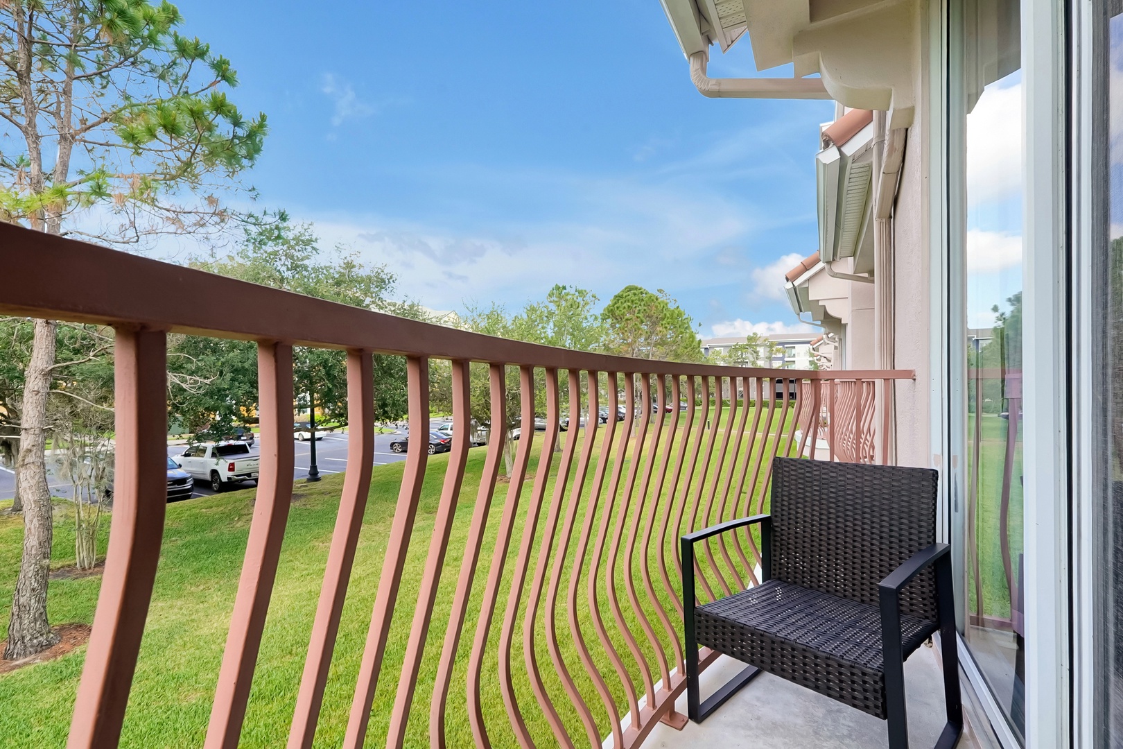 Step onto your private balcony and breathe in the fresh air while enjoying peaceful views of the lush green lawn.