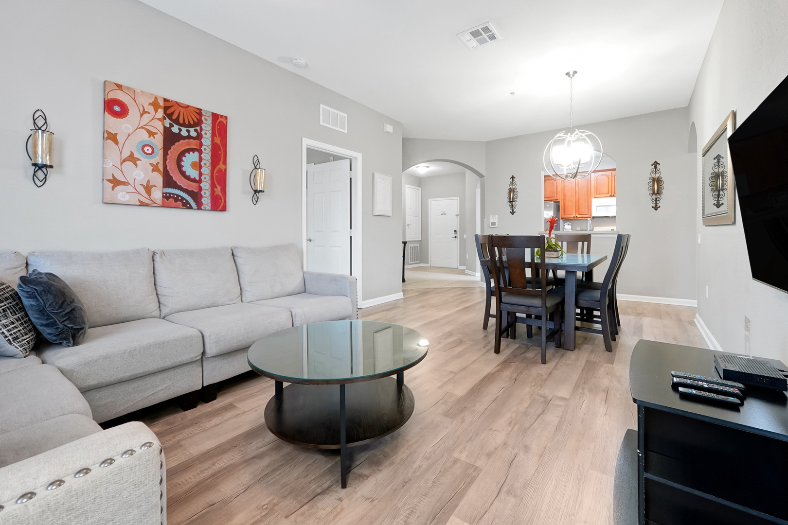 Settle into your inviting living space with plush seating, modern décor, and an open layout that flows seamlessly into the dining area and kitchen—perfect for relaxing or gathering together.