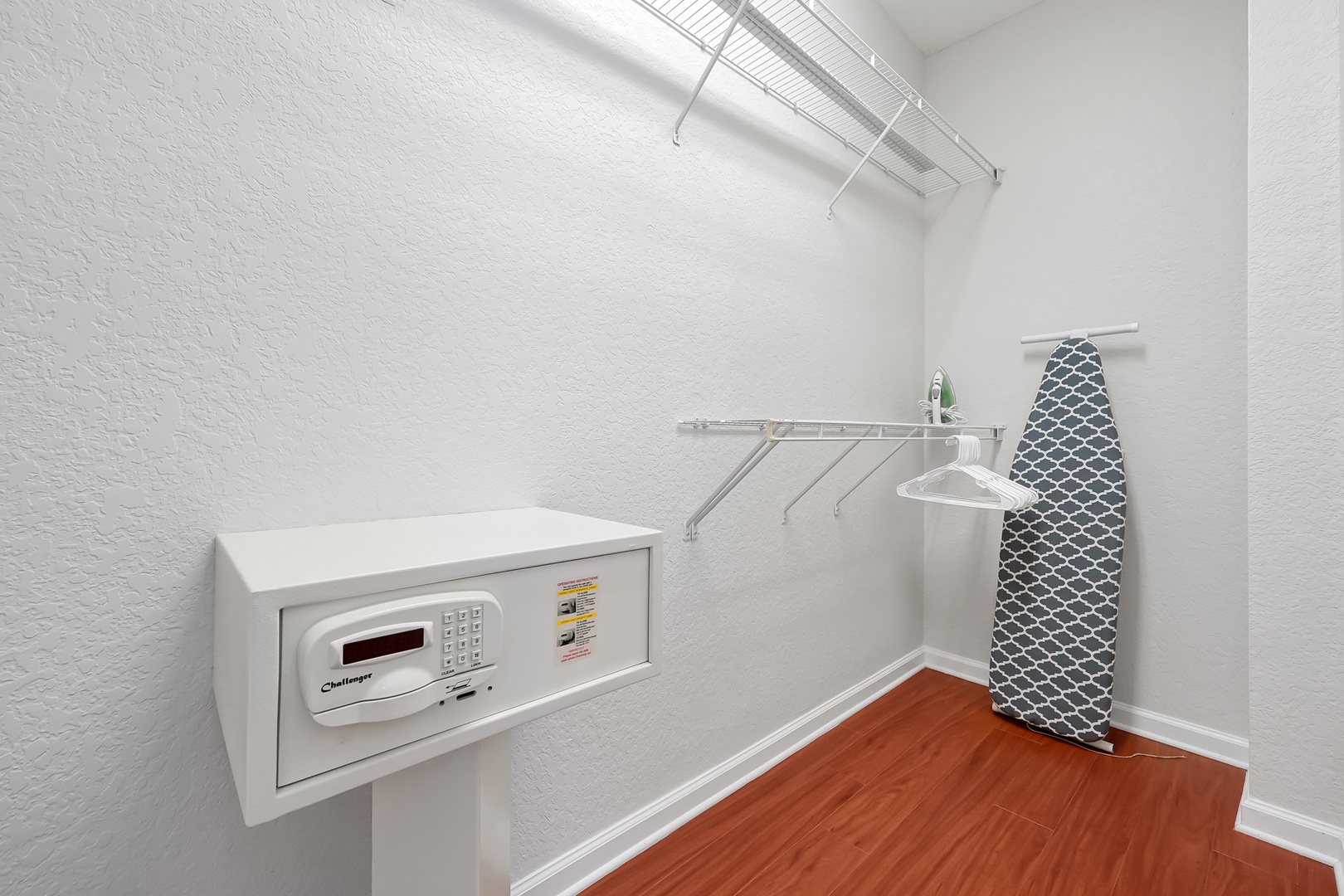 Your private laundry room features a modern washer, built-in ironing board, and organized shelving for effortless garment care during your stay.