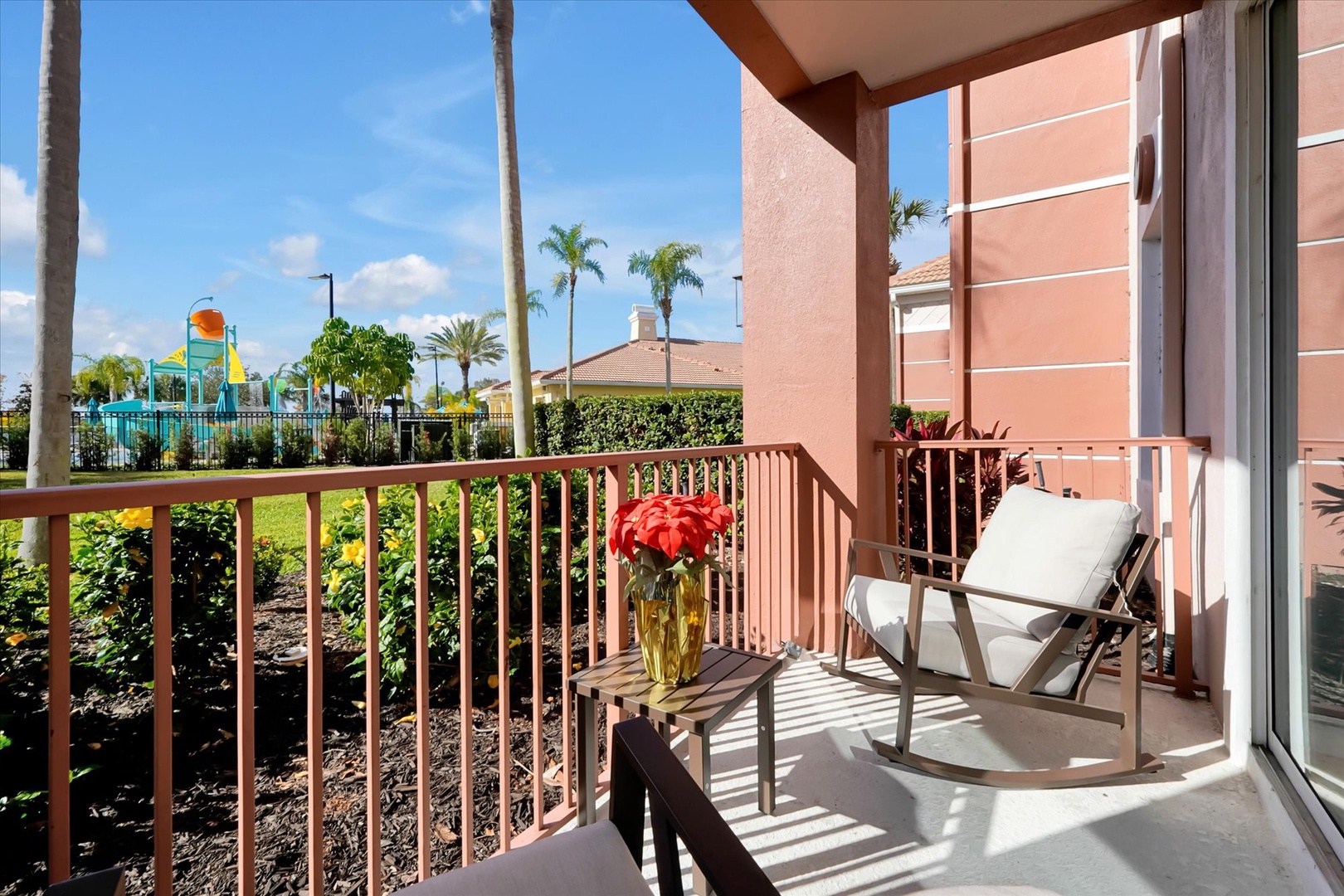 Unwind on your private balcony with comfortable seating and tropical views of the aqua park and palm trees.
