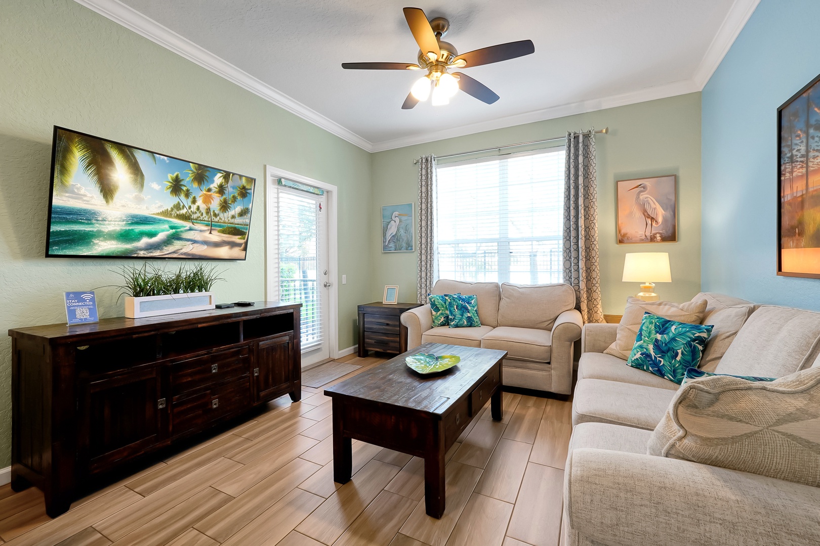 Relax in your coastal-inspired living room with plush seating, tropical décor, and modern entertainment for perfect vacation evenings together.