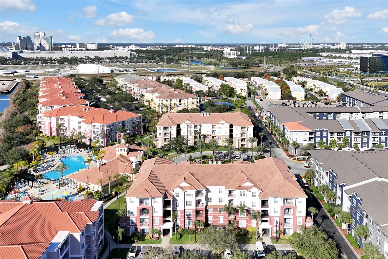 Aerial view of the resort complex showcasing Mediterranean-style buildings, swimming pool amenities, and convenient Orlando area location with nearby attractions.