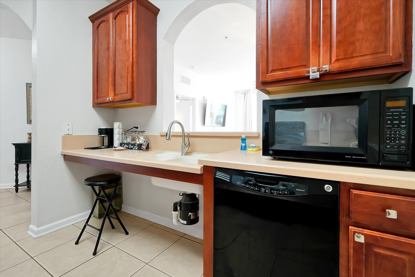 Your fully equipped kitchen features warm cherry cabinets, modern appliances, and a convenient breakfast bar for quick meals.