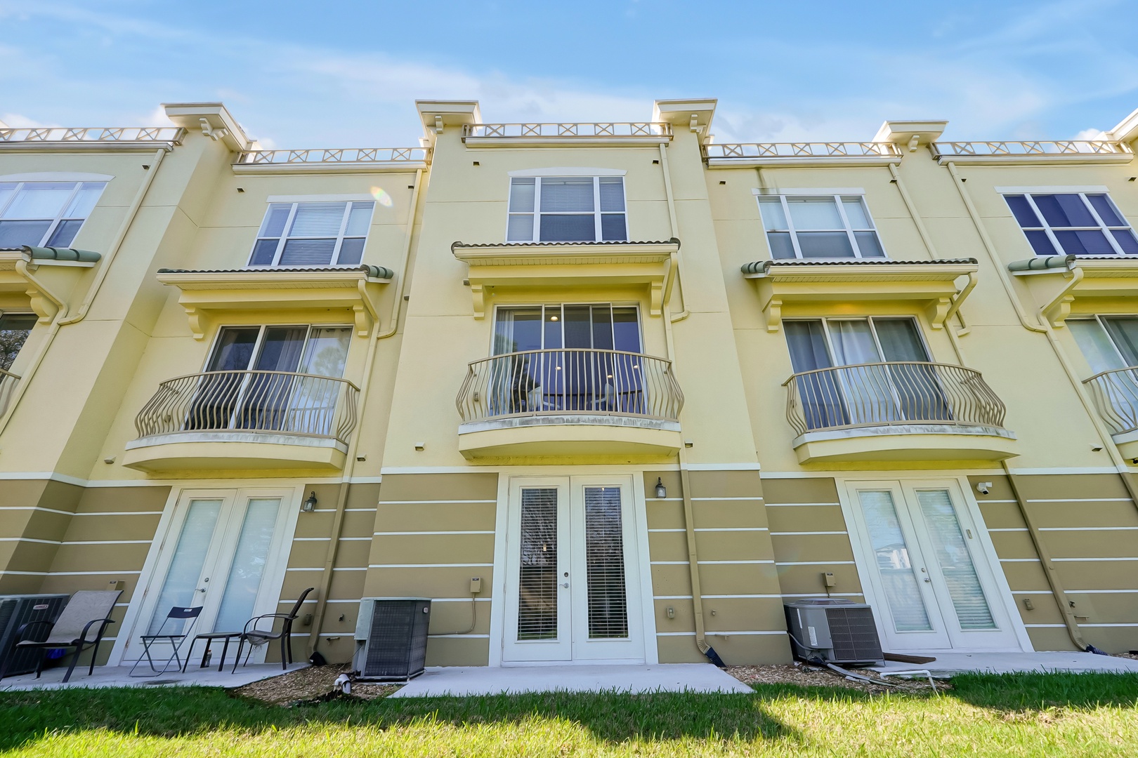Modern townhome featuring elegant balconies and spacious patios where you can unwind in comfort and style.