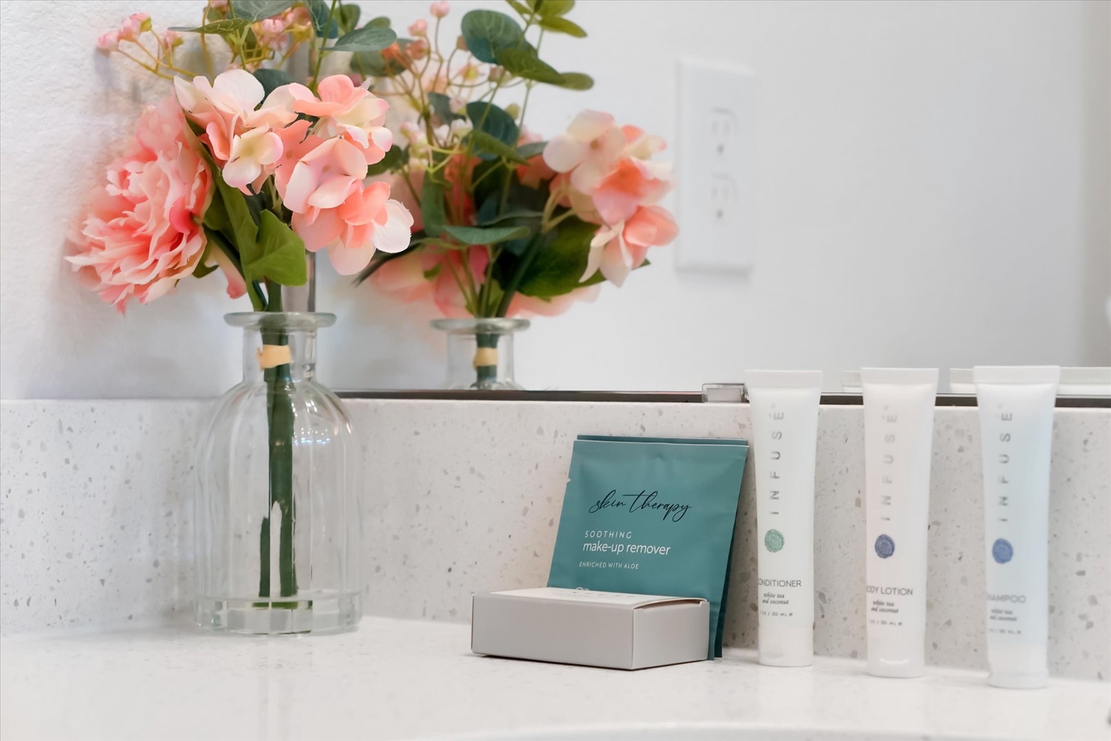 Soft pink blooms and premium bath amenities await your arrival, adding a fresh, elegant touch to your stay.