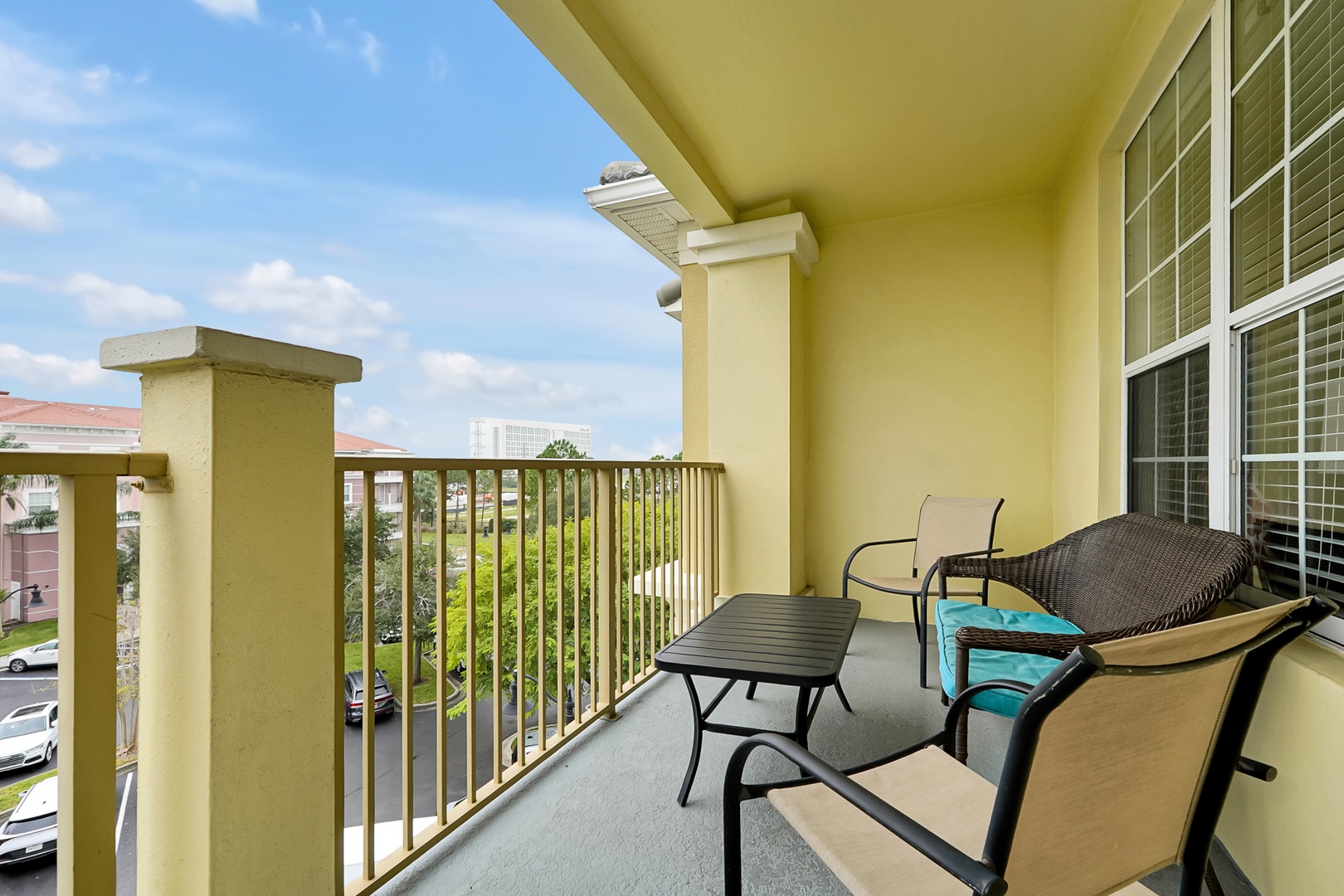 Step out onto your private balcony and settle into the cozy outdoor seating with views of the surrounding neighborhood and distant cityscape.