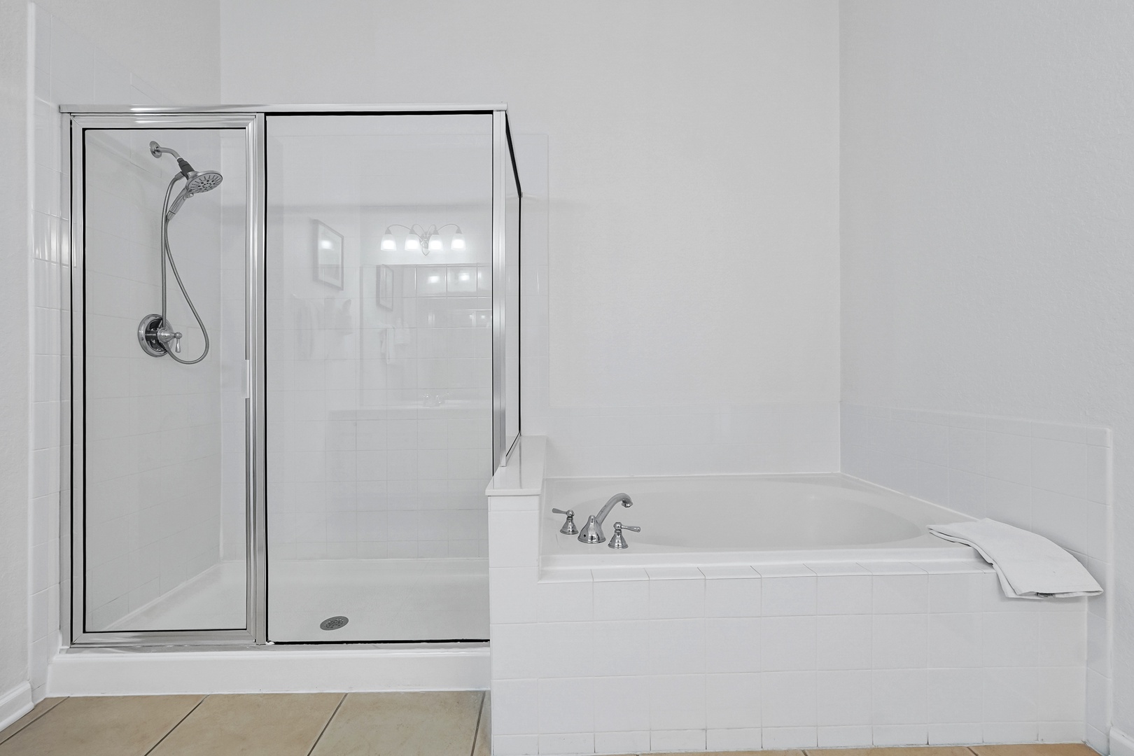 Relax in your private bathroom featuring both a glass-enclosed shower and a spacious soaking tub—perfect for unwinding after a day of exploring.