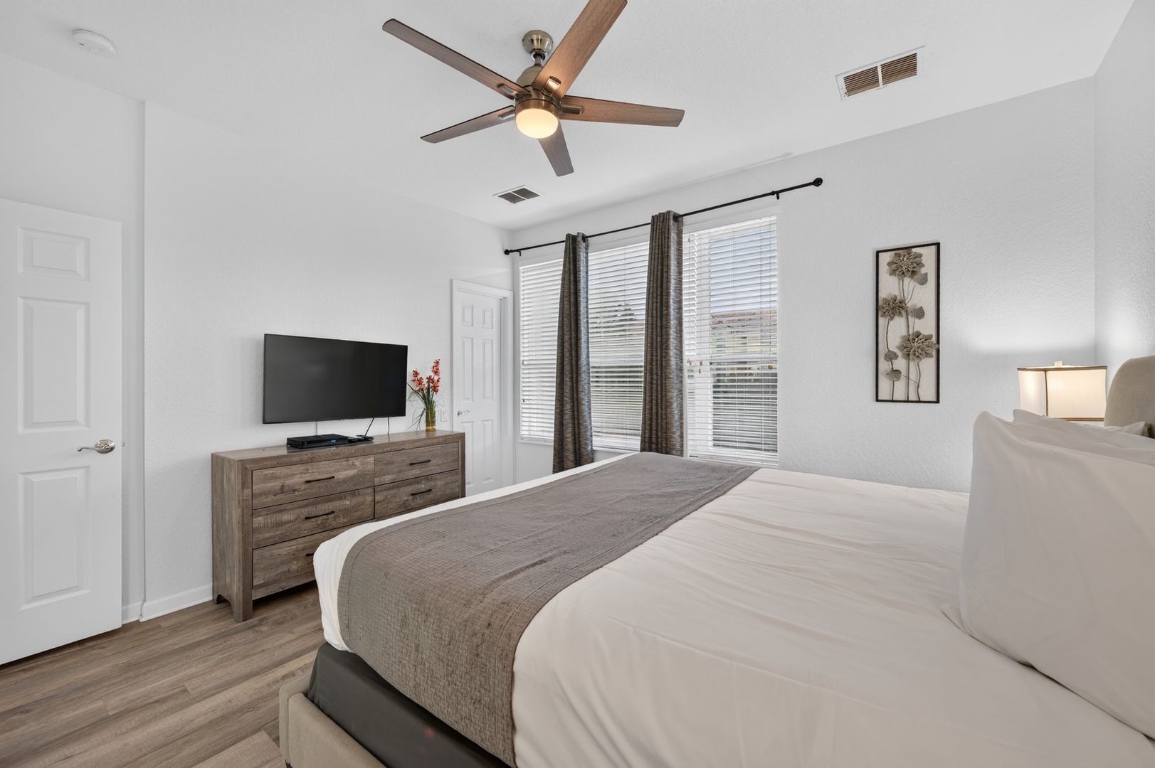 Unwind in your bright, serene bedroom with vaulted ceilings and a ceiling fan for your comfort. Cozy bedding and calming neutral tones invite restful nights after your adventures.