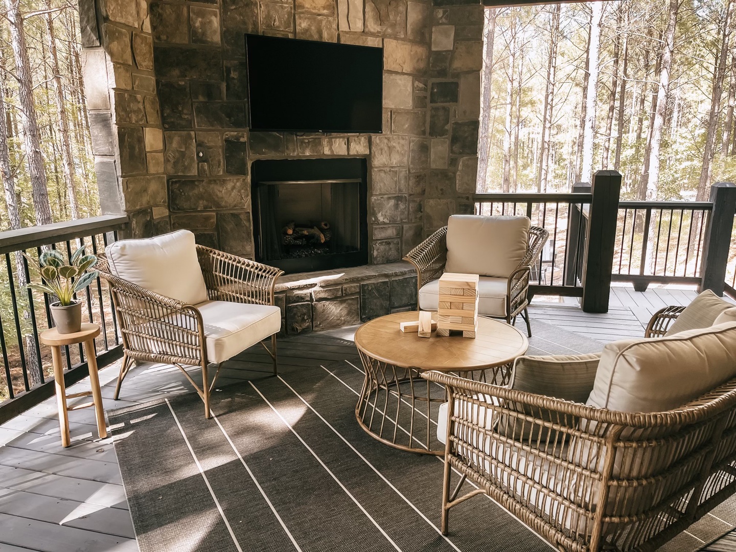 Gas-burning fireplace, TV, and seating on back patio