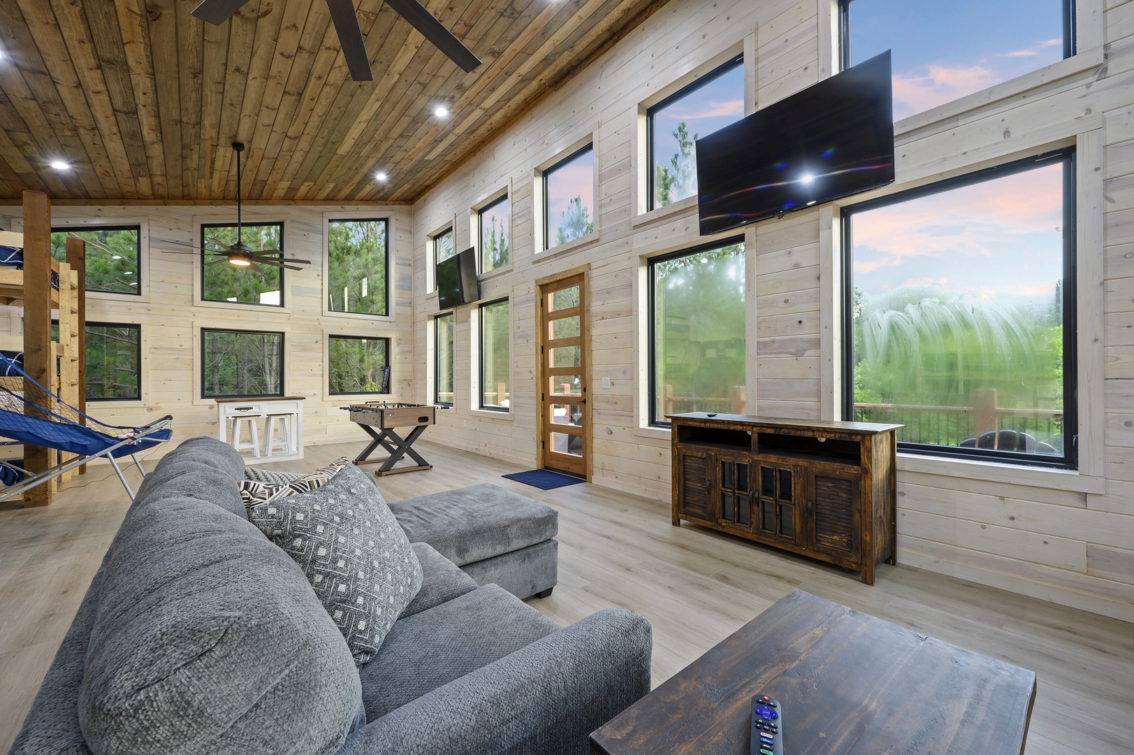 Floor-to-ceiling windows provide beautiful forest views