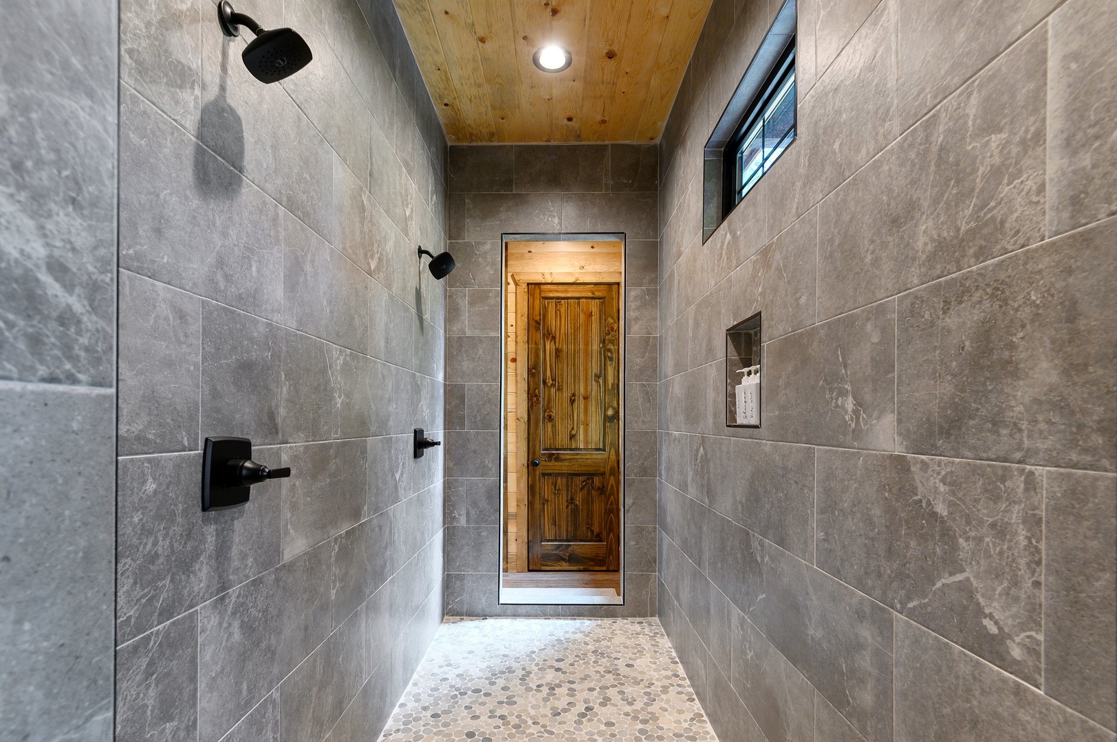 Oversized pass-thru shower with double shower heads