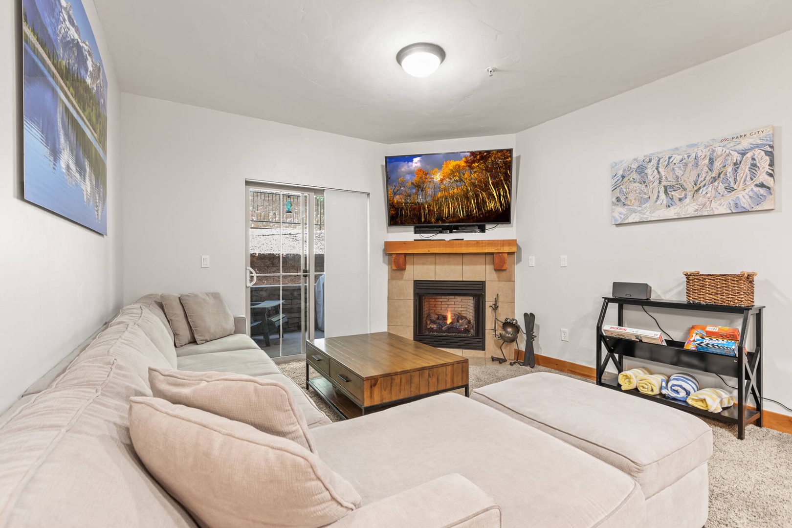 Bear Hollow Lodges 4203: This cozy condo has a warm and inviting design, with a spacious sectional sofa and a tiled corner fireplace.
