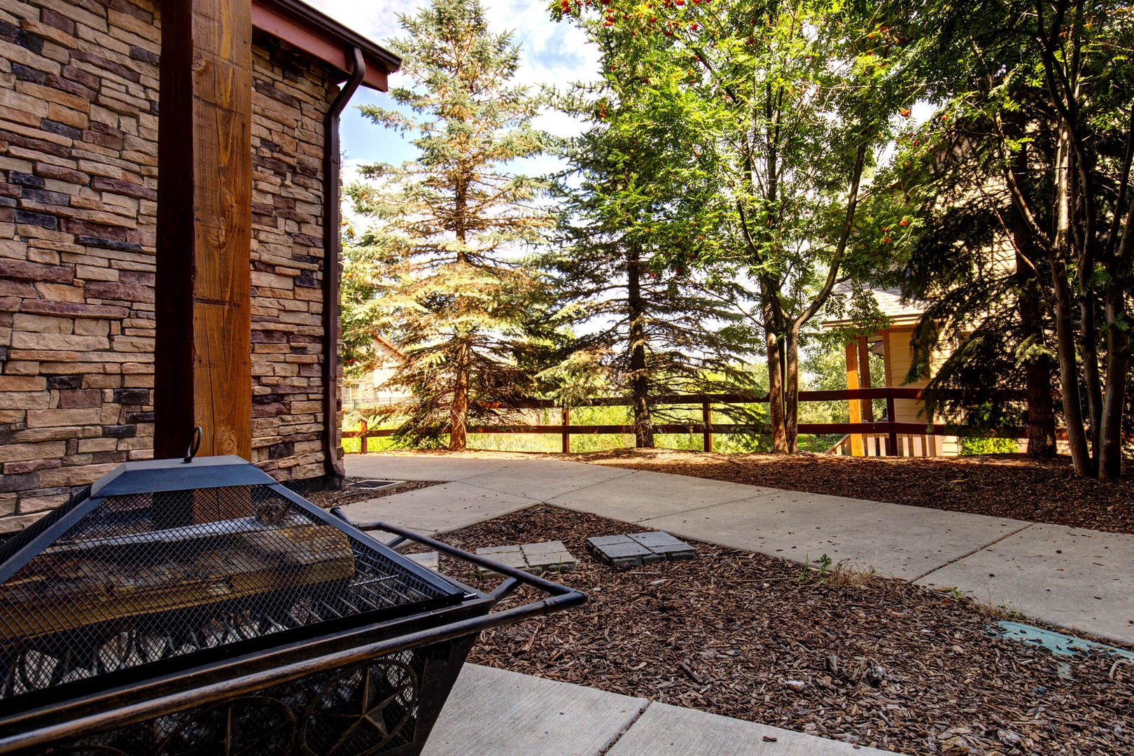 Bear Hollow Lodges 1104: A walk-out patio with seating and a fire pit.  Take a deep breath of the mountain air.