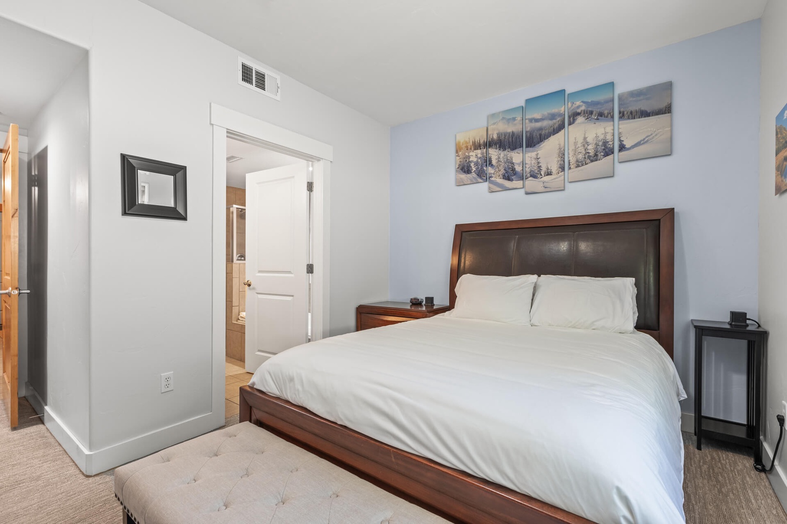 Bear Hollow Lodges 4203: In the PRIMARY BEDROOM SUITE, you’ll find a sumptuous queen-size bed and a small desk space.