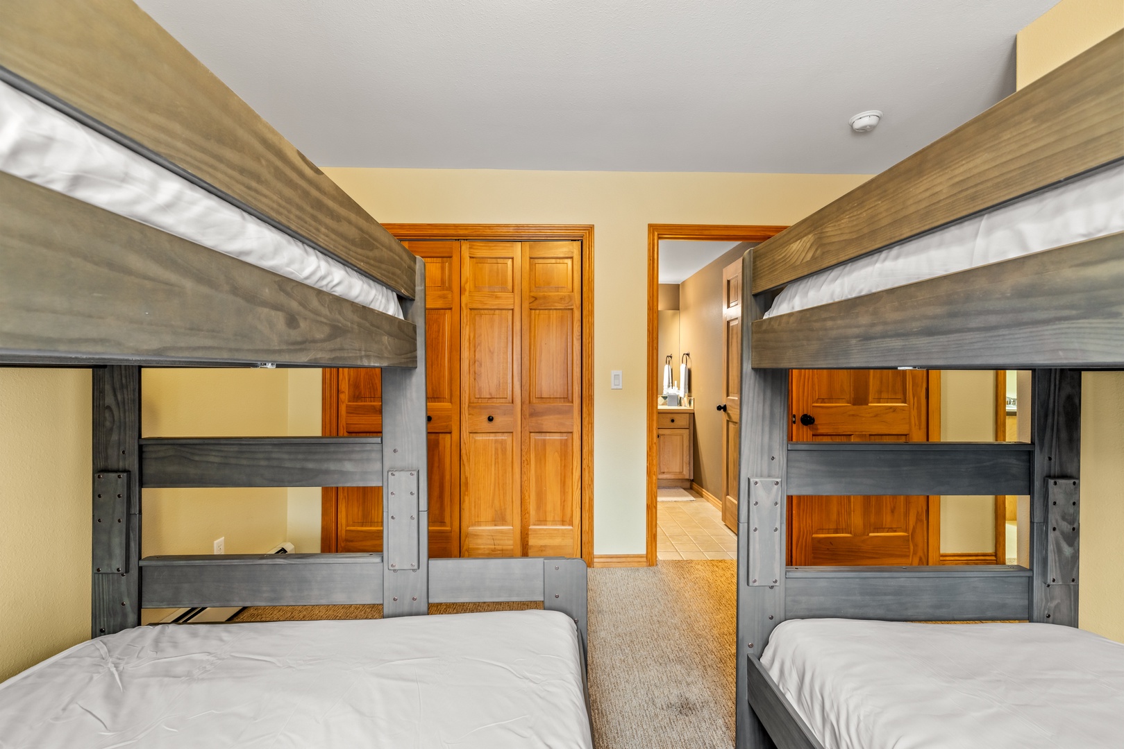 Cozy bunk beds create perfect sleeping arrangements for your group, with plenty of space and built-in storage for everyone's comfort.