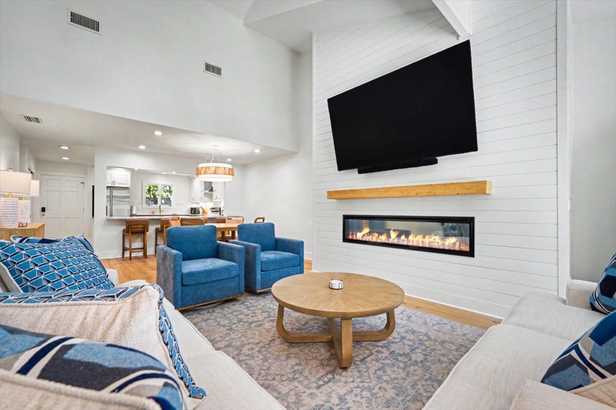 Unwind in your open-concept living space with soaring ceilings, cozy fireplace, and entertainment center perfectly positioned for movie nights.