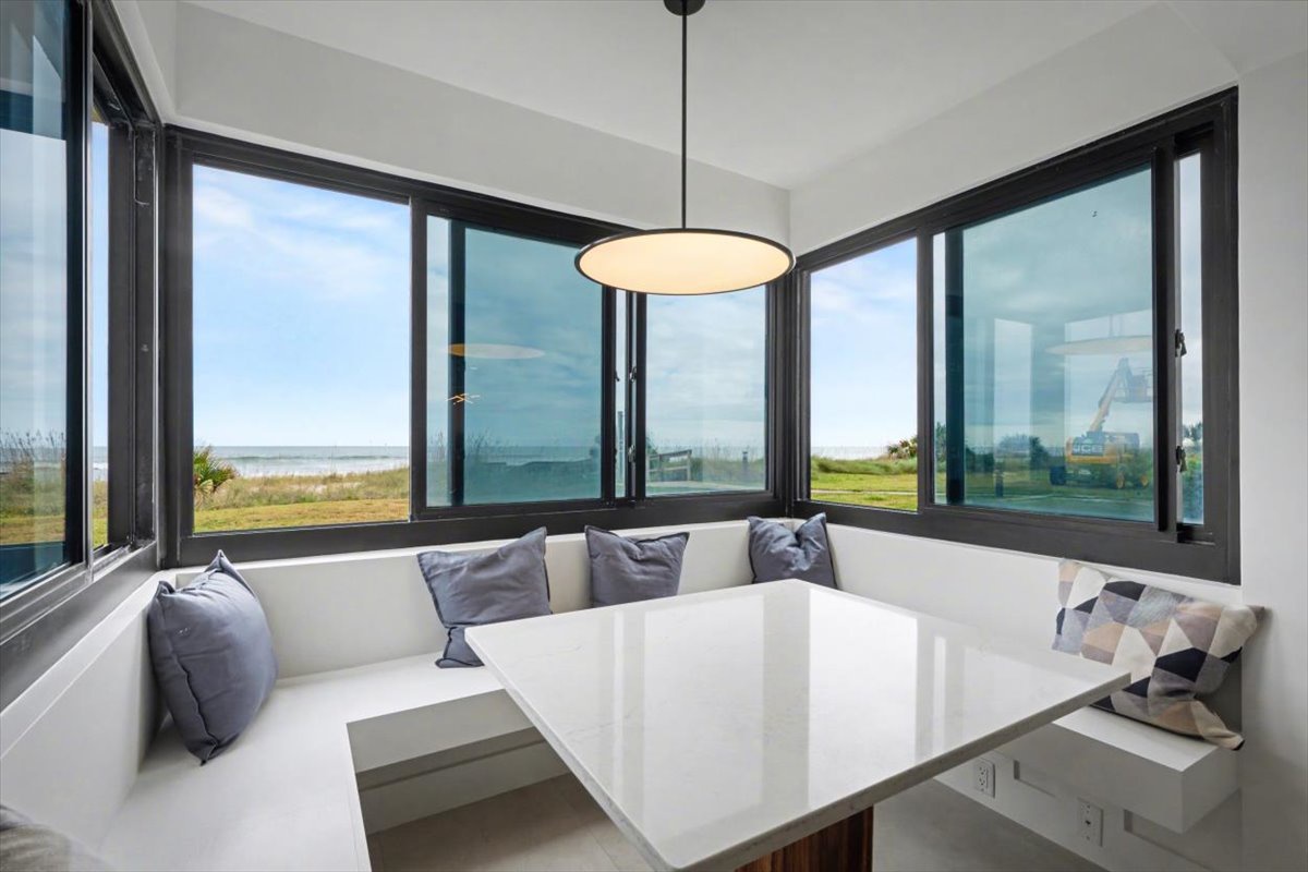 Settle into your corner dining nook with panoramic windows framing endless views—perfect for morning coffee or evening meals.