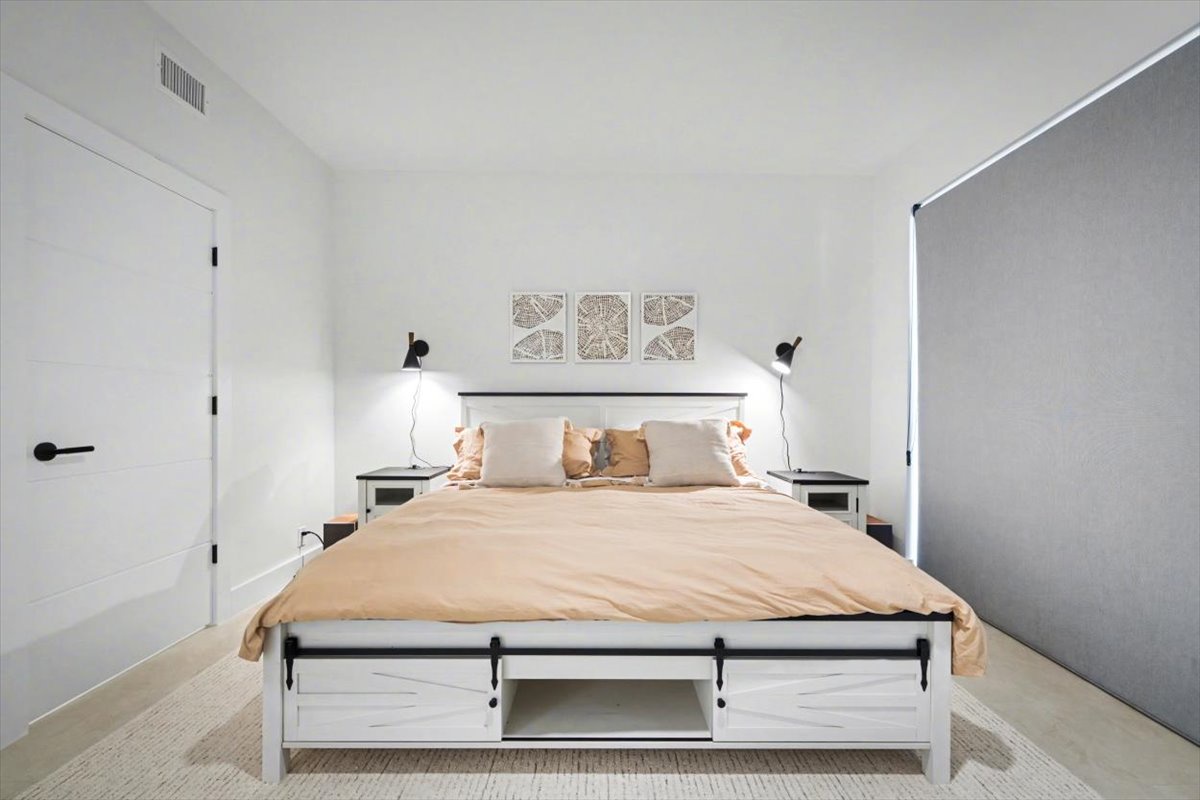 Drift into peaceful sleep in your beautifully appointed bedroom, where modern comfort meets minimalist elegance.