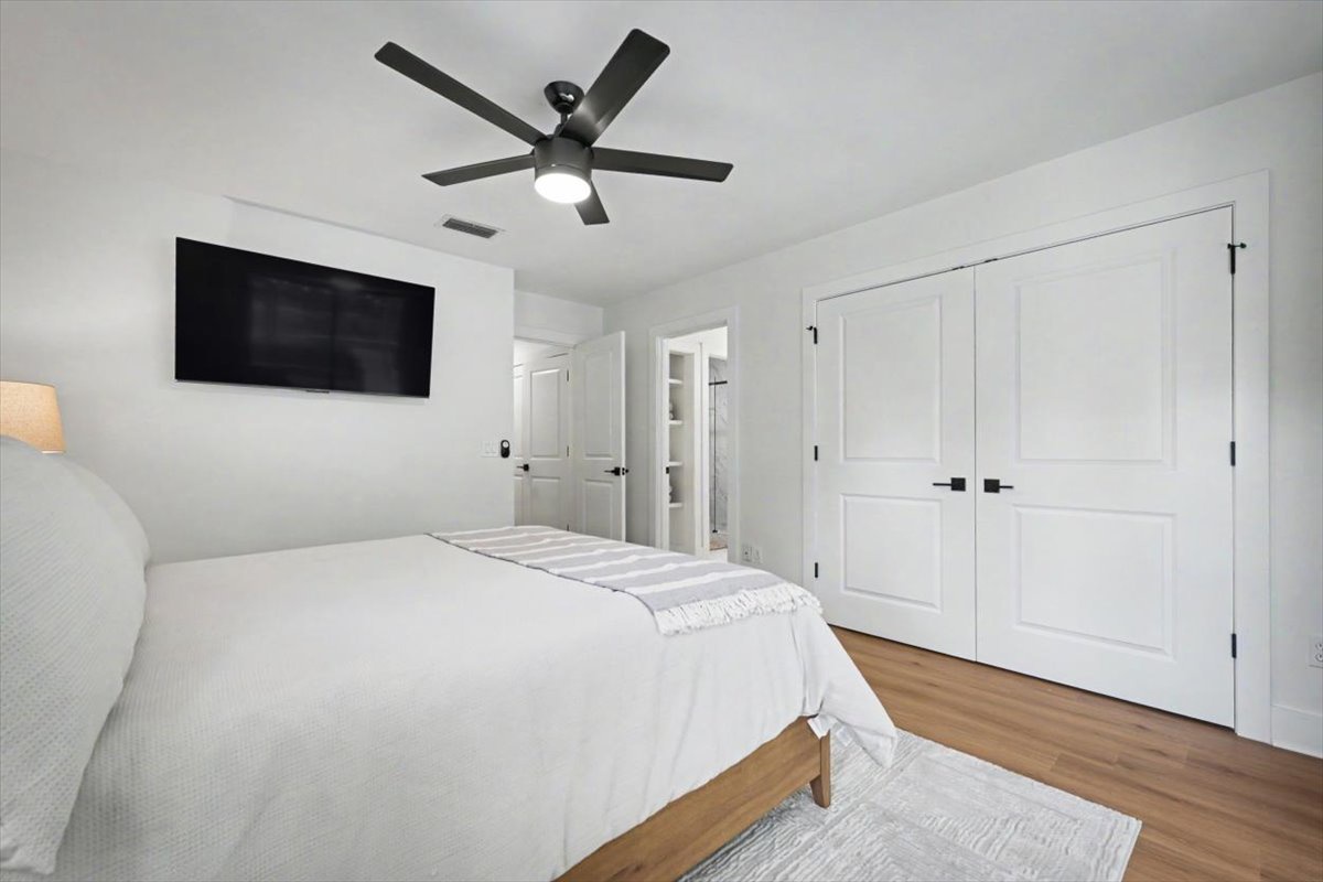 Rest easy in your bright bedroom with plush bedding, ceiling fan, TV, and ample closet space for all your belongings.