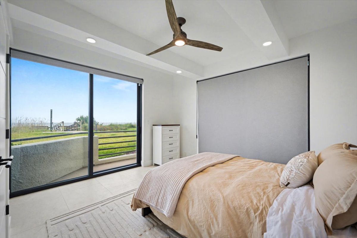 Drift off in your serene bedroom with expansive windows framing peaceful Oceanfront views and modern comfort at every turn.