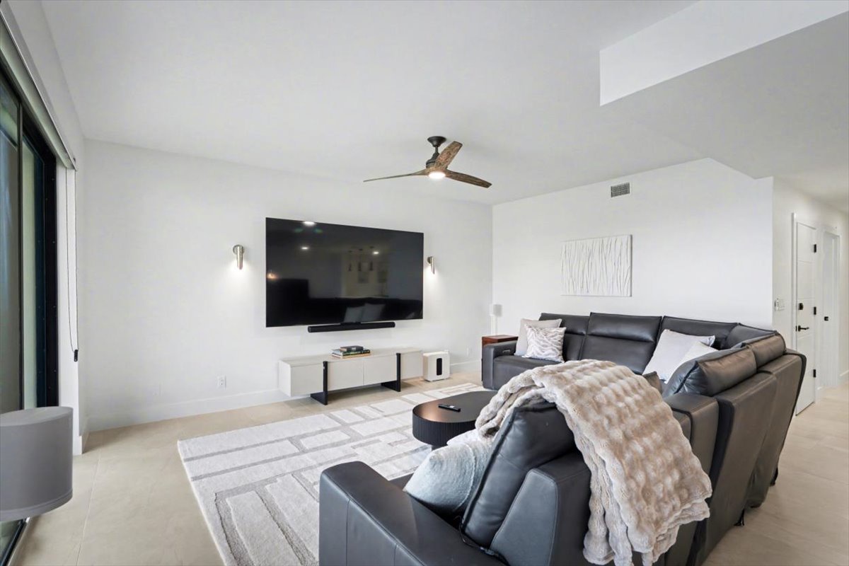 Sink into plush leather seating while you enjoy movie nights on the large wall-mounted TV in this modern living space.