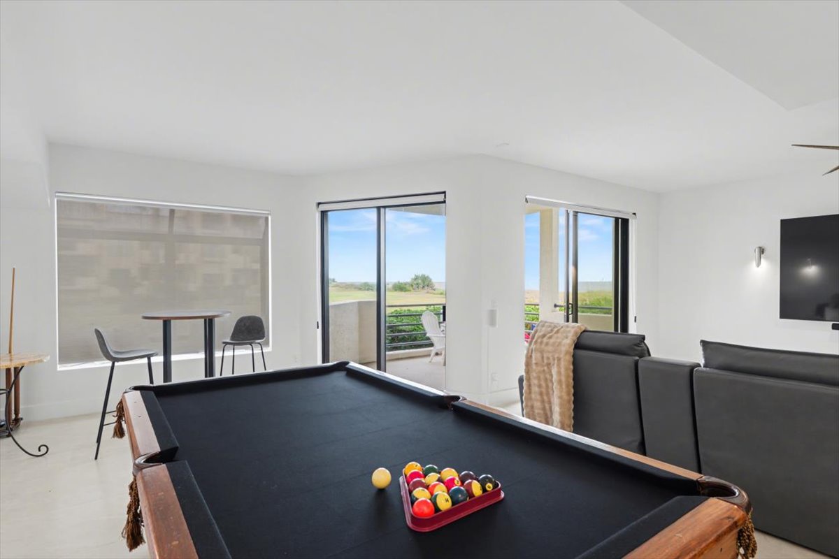 Challenge friends to pool while enjoying oceanfront views through floor-to-ceiling windows in your spacious entertainment room.