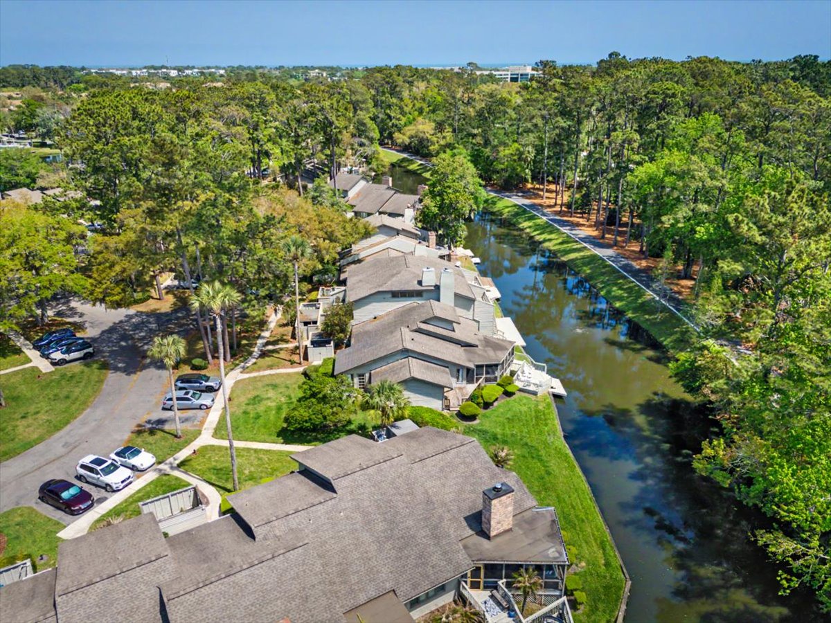 Waterfront townhomes nestled among mature trees with canal access and peaceful natural surroundings in a scenic residential community.