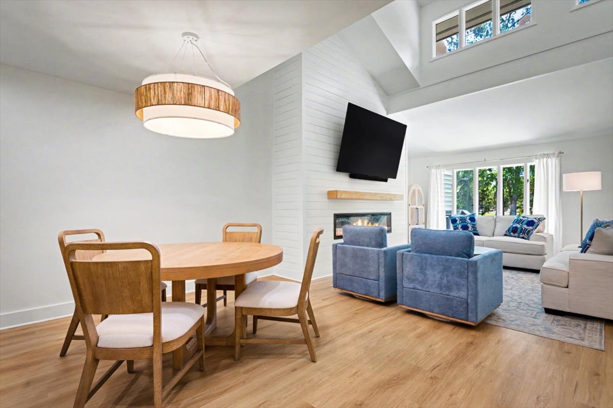 Relax in your bright open-concept space with cozy fireplace, stylish dining area, and comfortable seating perfect for unwinding after exploring.