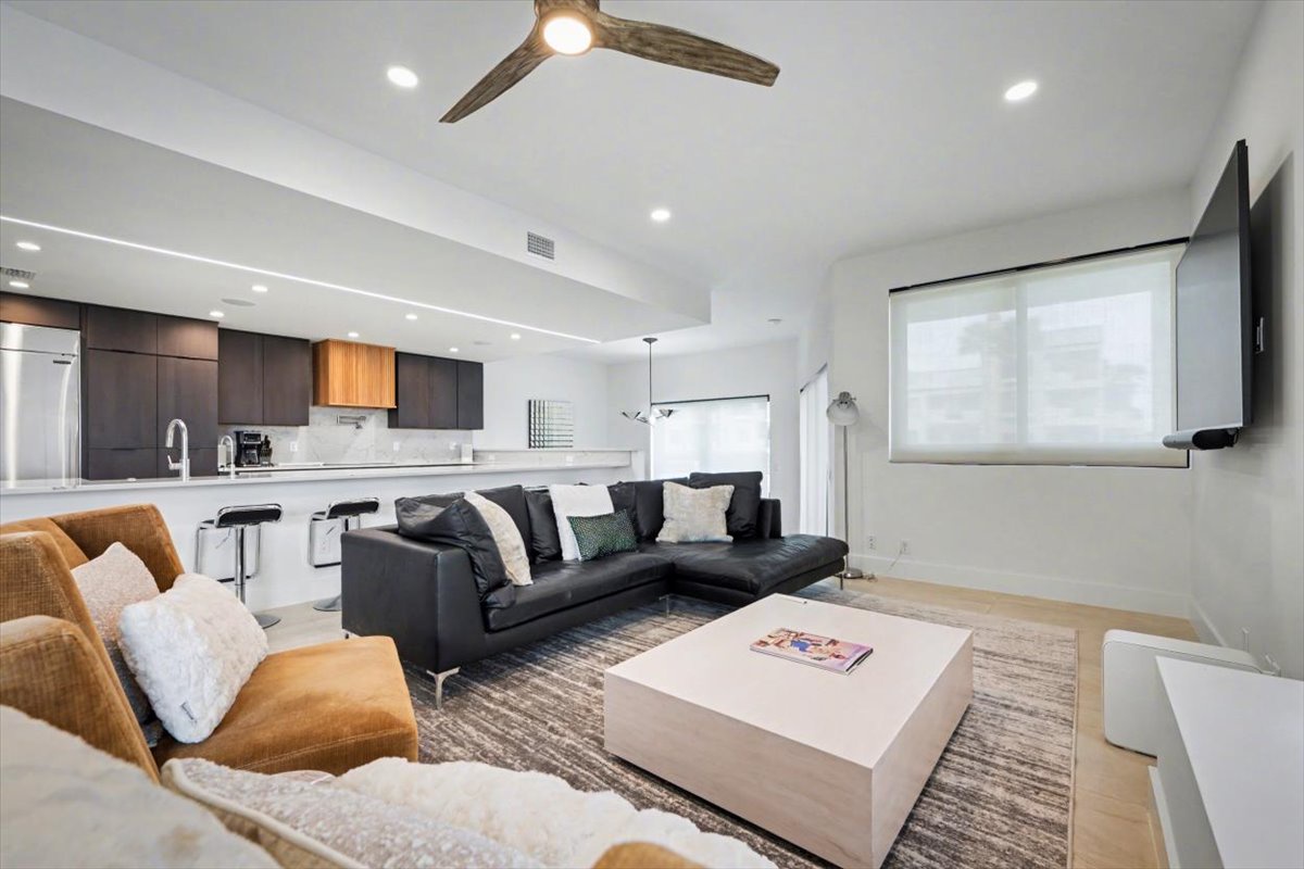 Relax in this sleek open-plan living space with a modern kitchen and comfortable seating area.