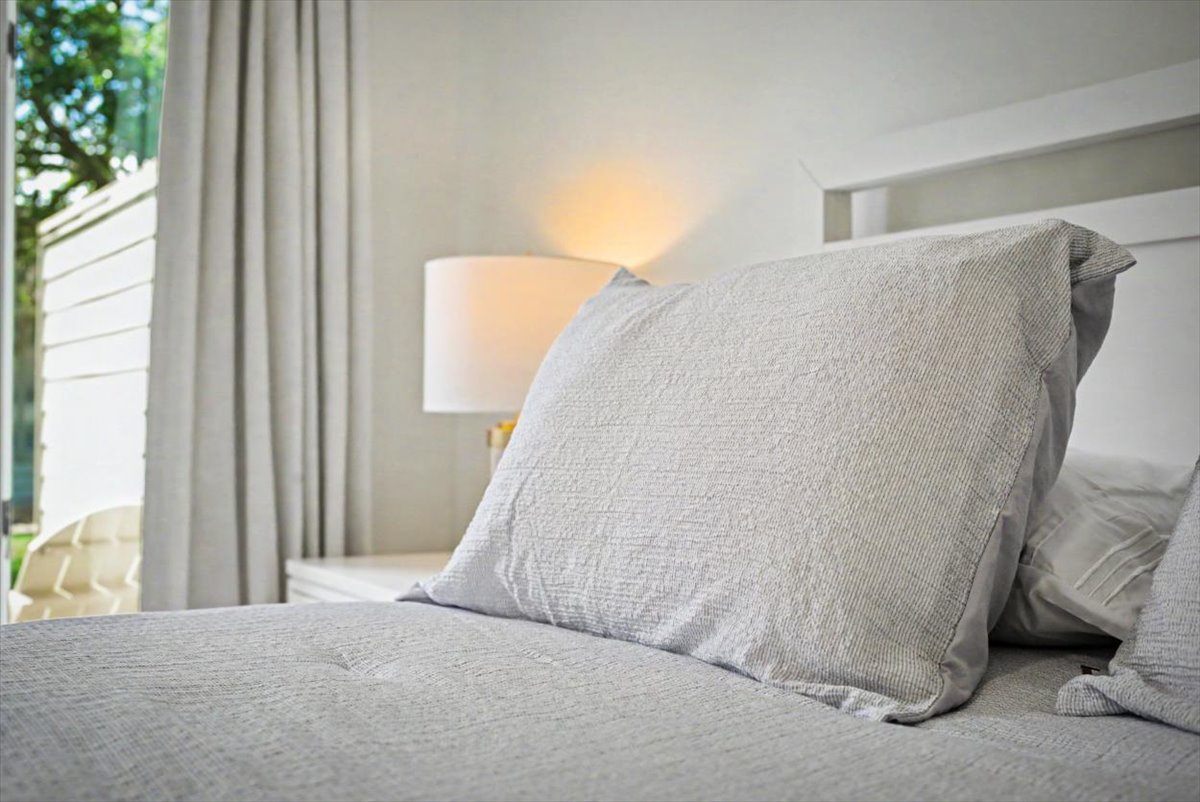 Sink into these plush gray linens and let the soft bedside lighting create your perfect evening sanctuary.