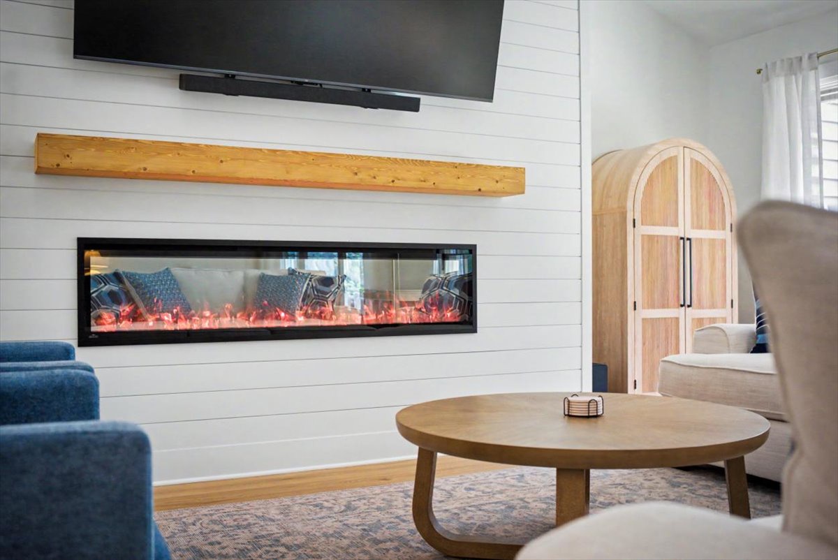 Cozy up in your stylish living room featuring a modern fireplace, flat-screen TV, and comfortable seating perfect for relaxing evenings.
