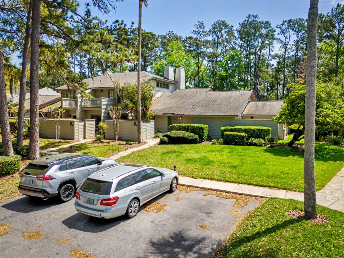 Contemporary vacation home nestled among towering trees with manicured landscaping and convenient parking in a peaceful wooded neighborhood.