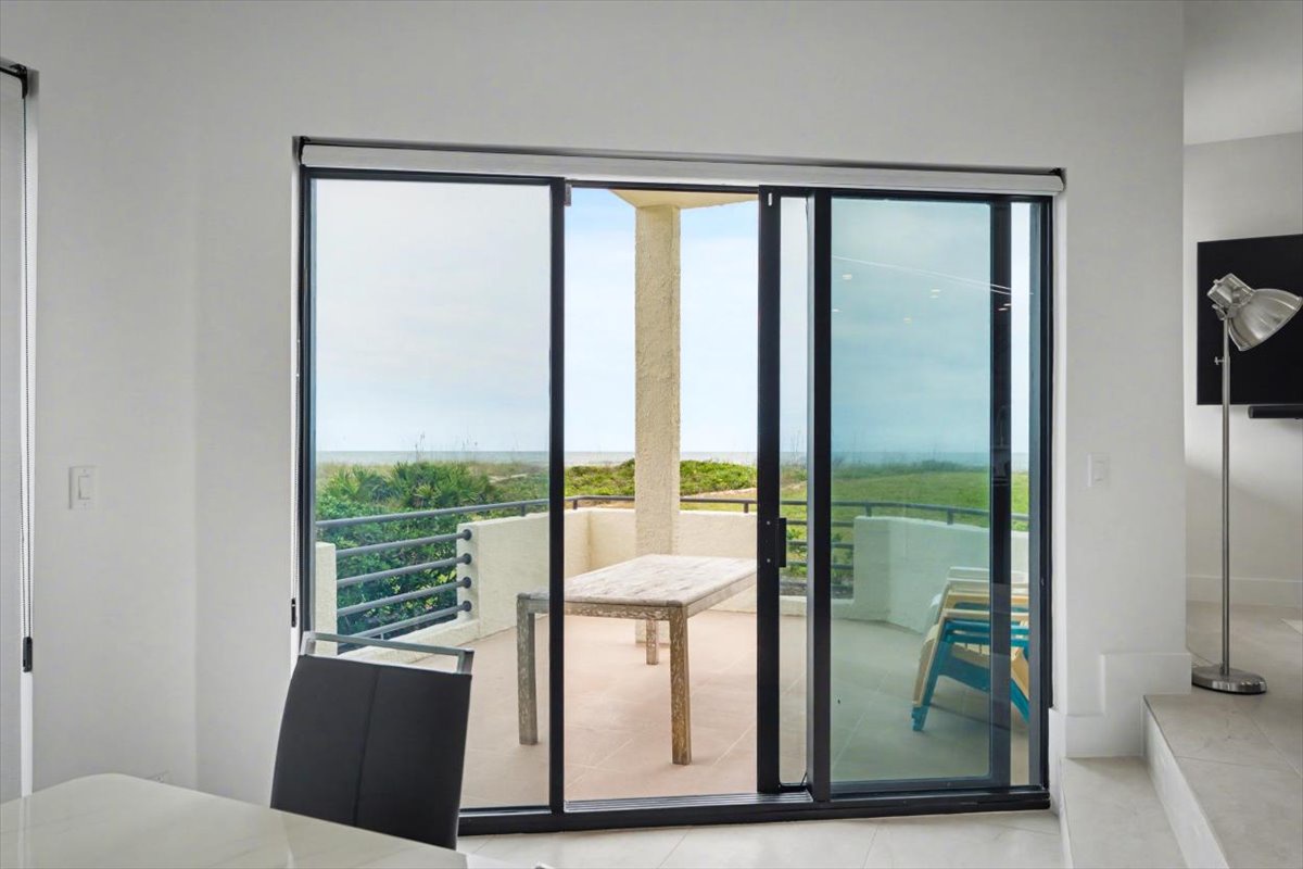 Step onto your private terrace through floor-to-ceiling glass doors and soak in panoramic views of lush greenery stretching to the horizon.