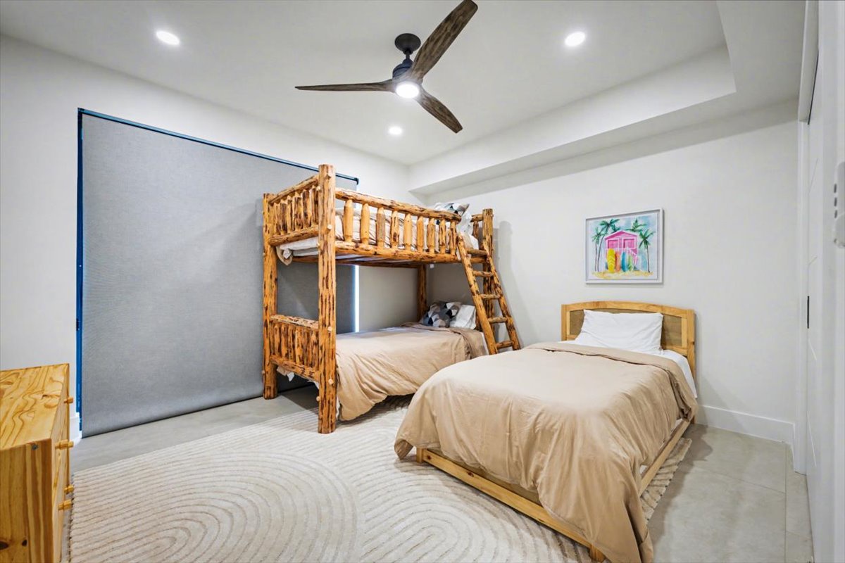 Kids will love this fun bedroom with rustic bunk beds and cozy single bed, perfect for family adventures.