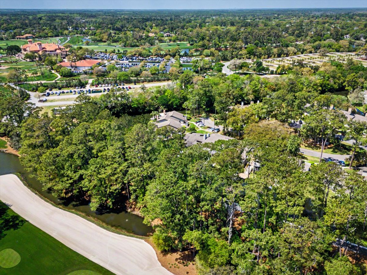 Aerial view of the resort community surrounded by lush greenery and golf course fairways in a peaceful suburban setting.
