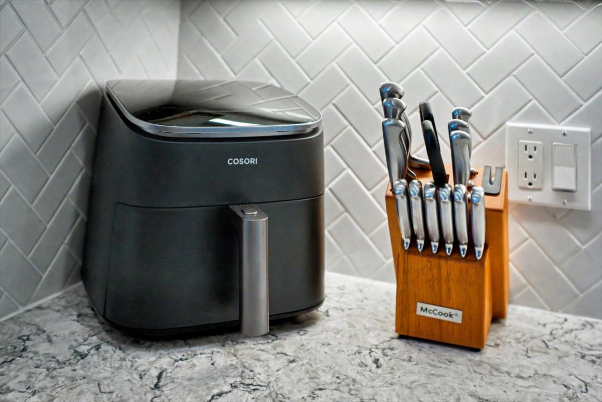 Your modern kitchen comes equipped with premium appliances including an air fryer and professional knife set for creating delicious meals.