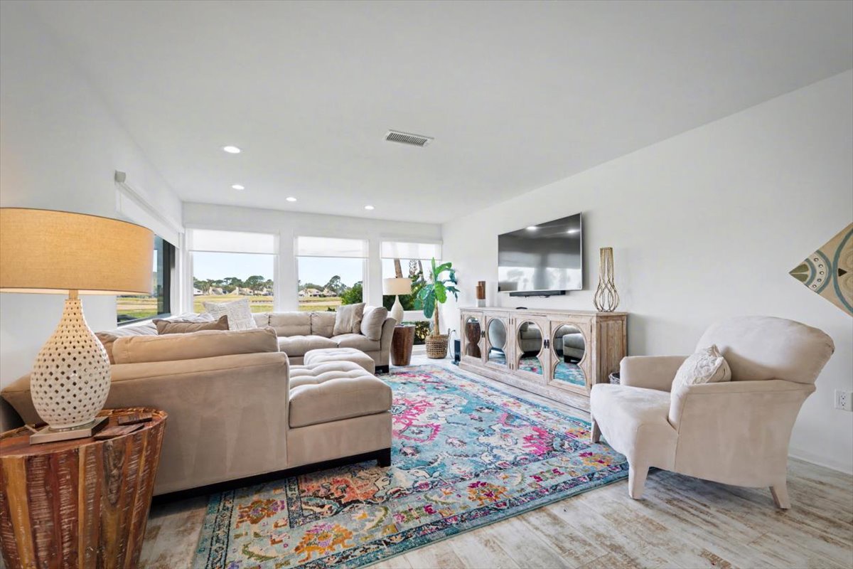 Unwind in your bright living room where plush sofas and vibrant rugs create a cozy retreat with stunning views.