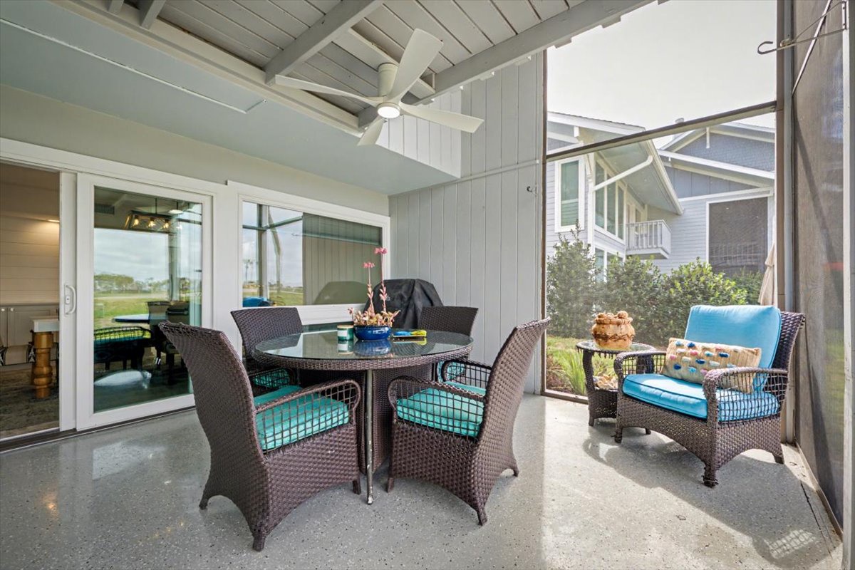 Relax on your private covered patio with stylish wicker seating and beautiful pool views, perfect for morning coffee or evening cocktails.