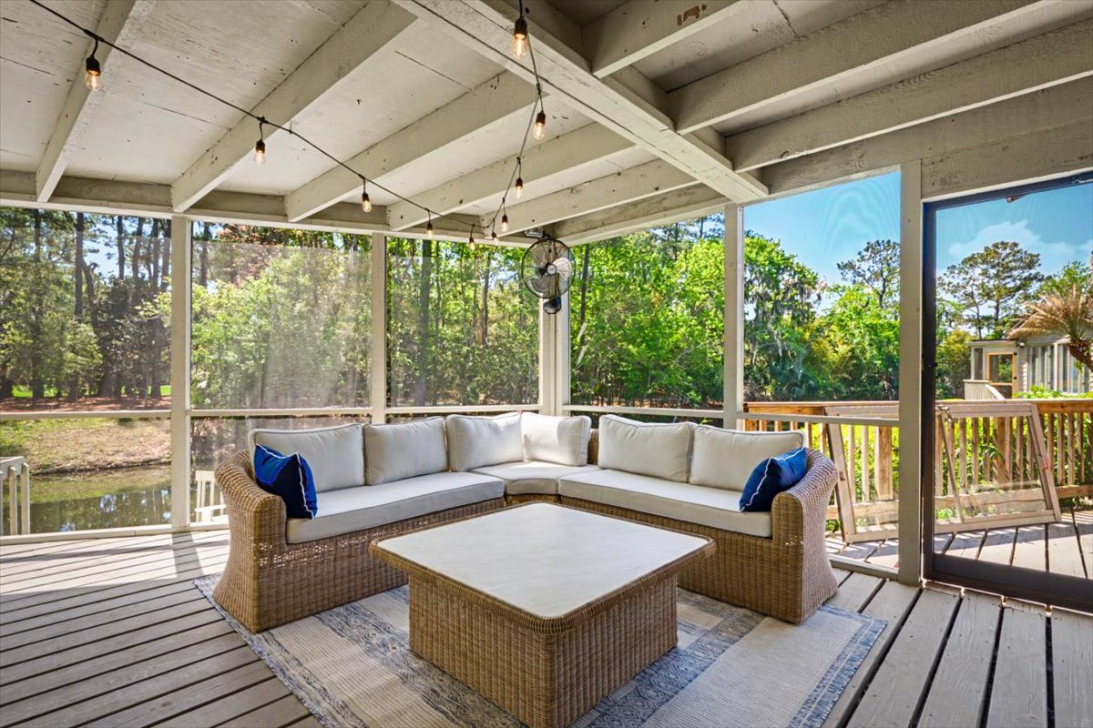 Unwind on your private screened porch with comfortable sectional seating overlooking peaceful wooded grounds.