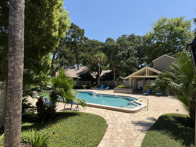 Relax by your private pool surrounded by lush tropical gardens and towering shade trees. The spacious patio offers the perfect spot to unwind under sunny skies.