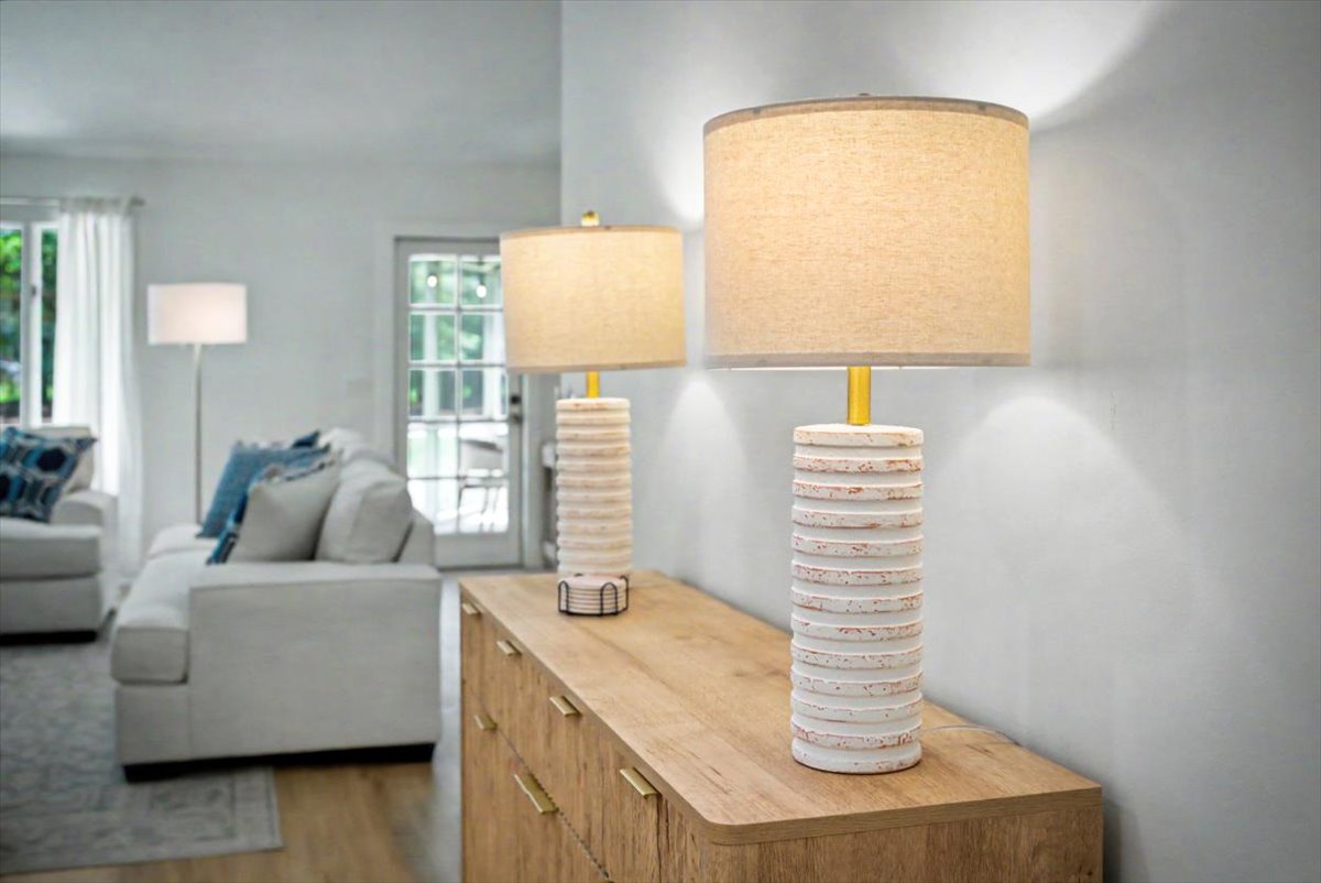 Warm up your evenings with stylish table lamps casting a golden glow throughout your comfortable living space.