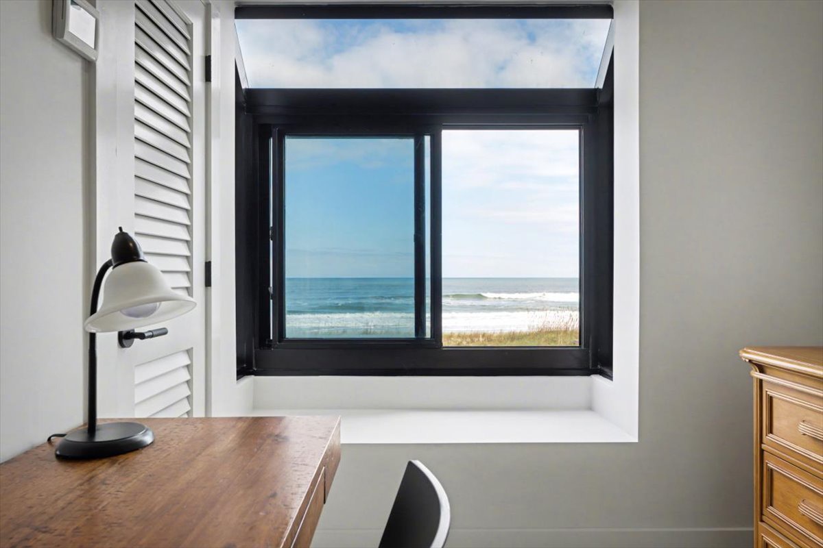 Picture yourself working at this window-side desk while waves crash just beyond your view - the perfect blend of productivity and paradise.